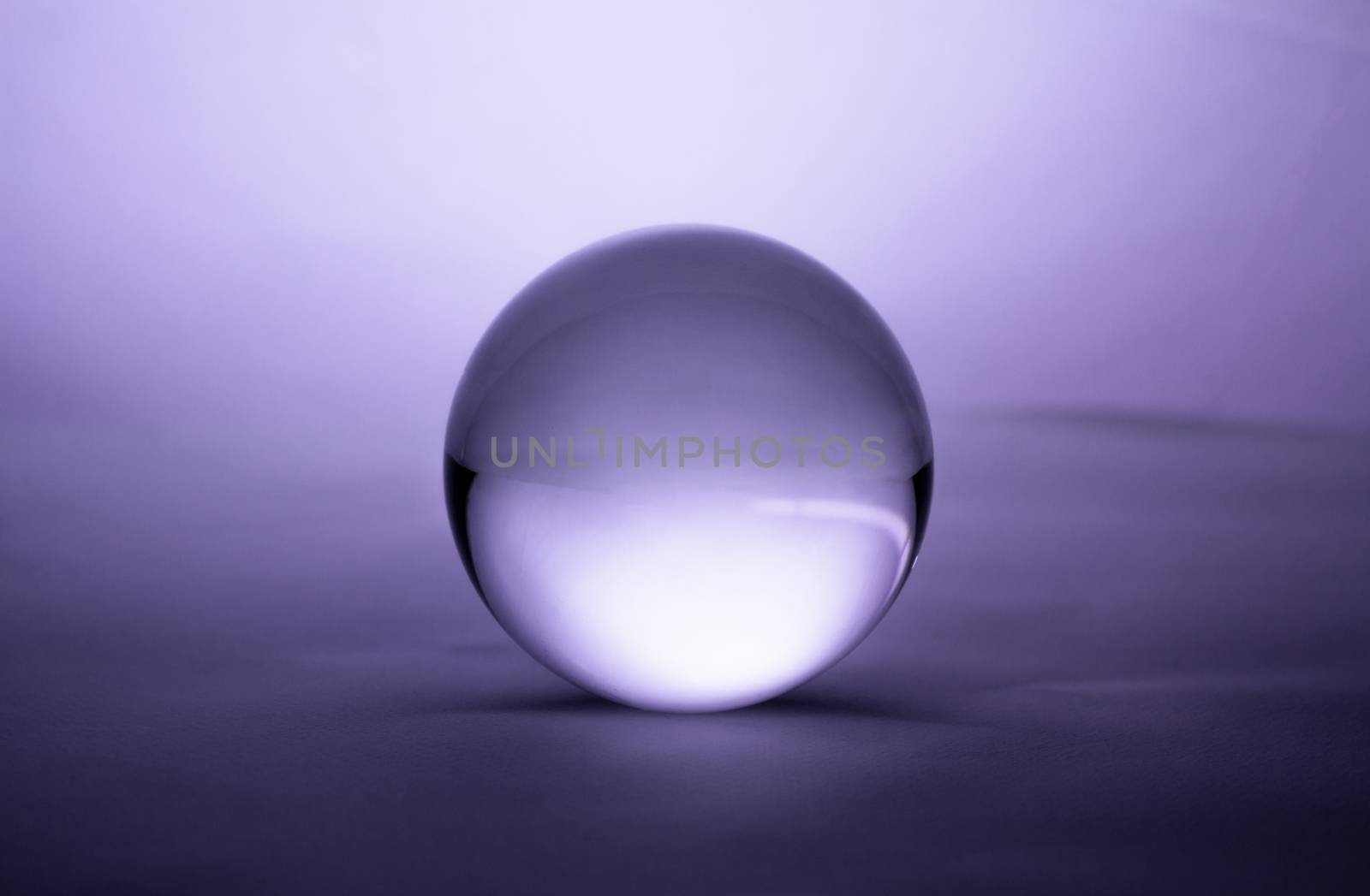 Crystal glass ball sphere transparent on purple gradient background. by TEERASAK