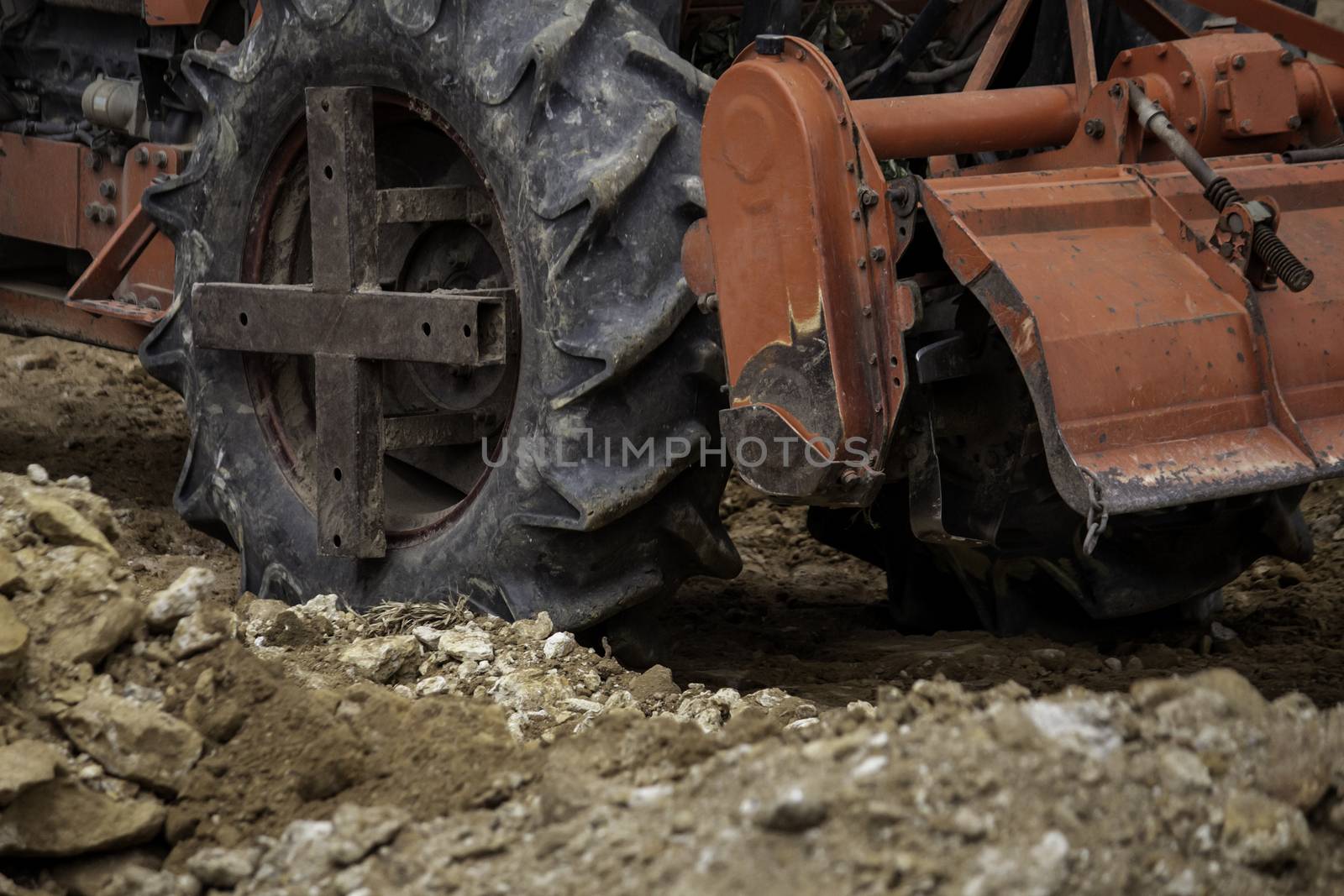 The tractors are adjusting the surface soil to smooth for construction.