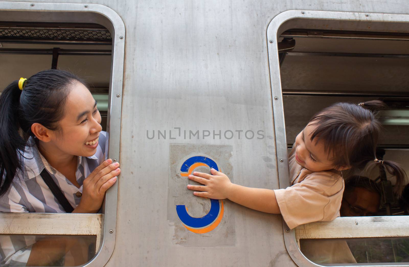Asian family sitting on Vintage diesel engine train at Khun Tan railway station, Lamphun Thailand.