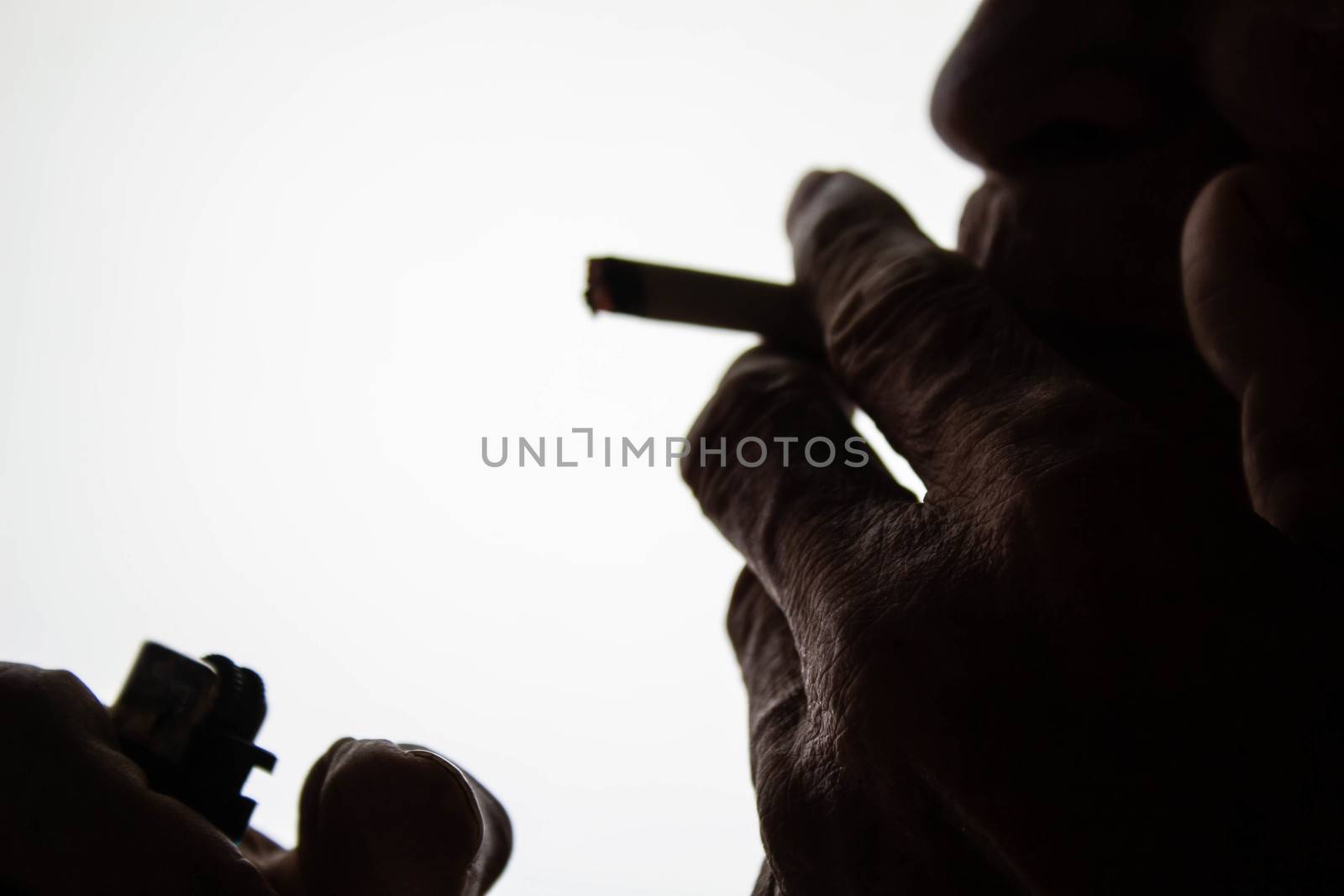 World No Tobacco Day; The silhouette of an elderly Asian man is smoking with space for idea text.