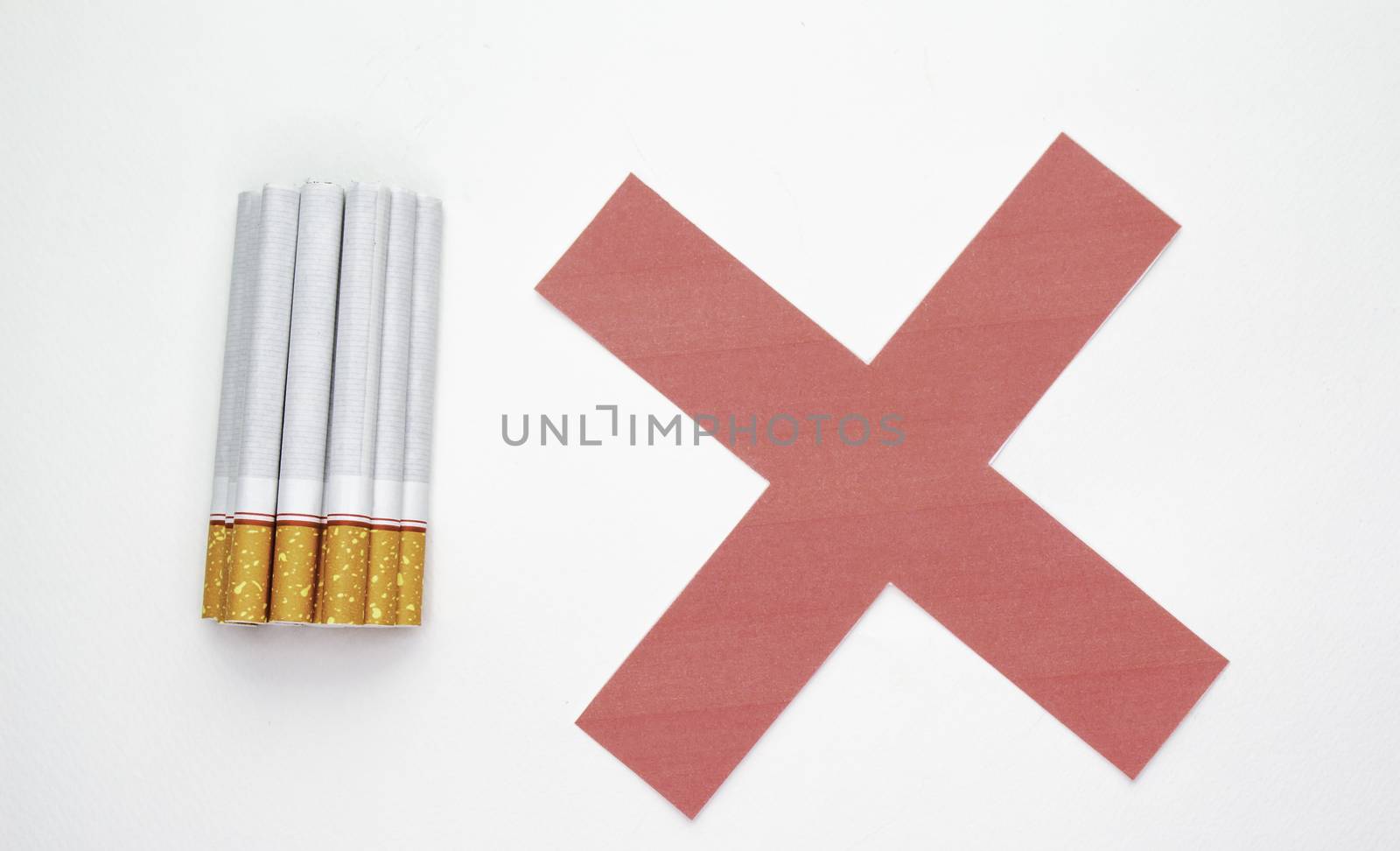 World No Tobacco Day; Heap of cigarettes with filter isolated on white background and Red cross symbol. by TEERASAK