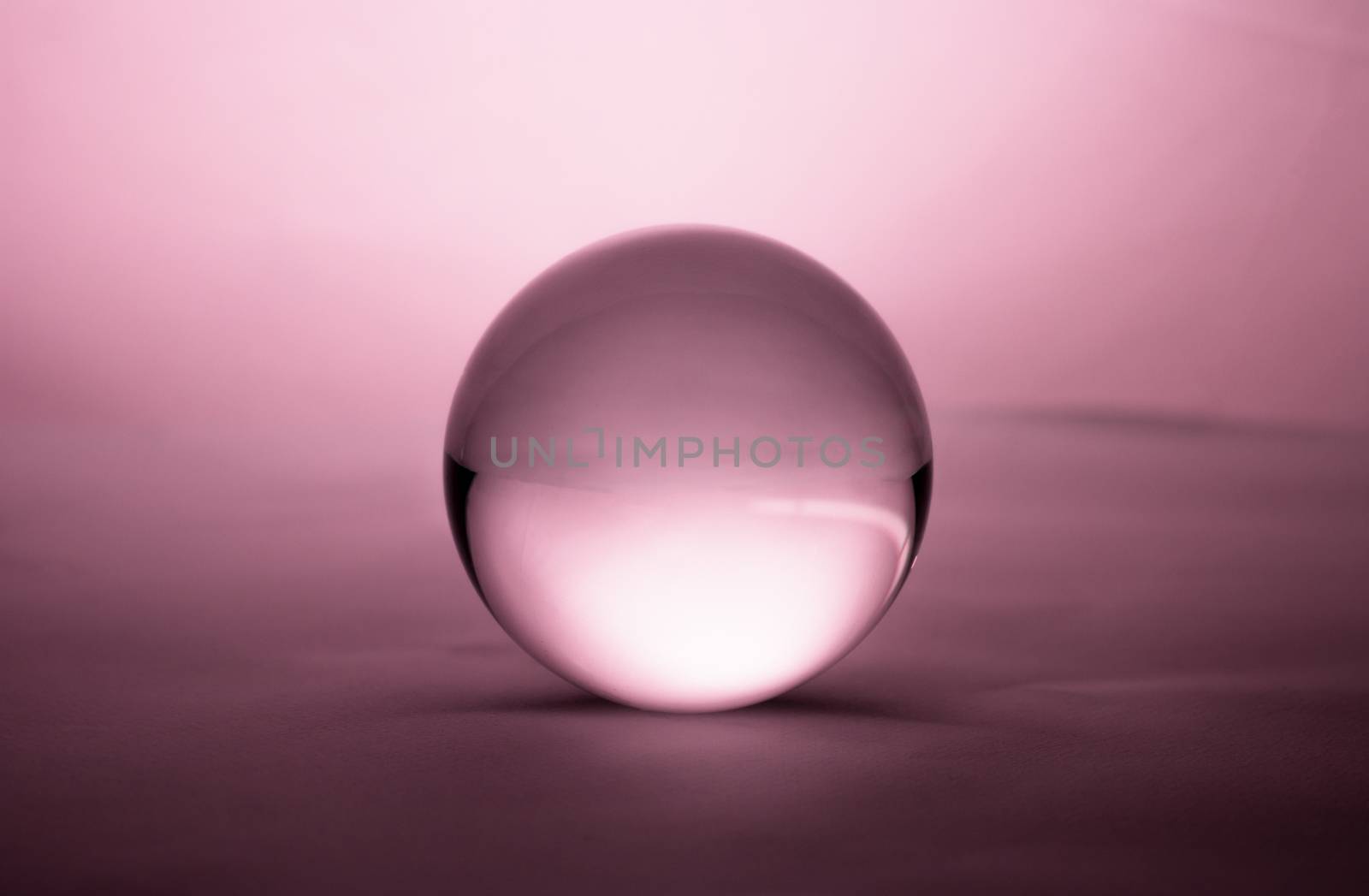 Crystal glass ball sphere transparent on pink gradient background. by TEERASAK