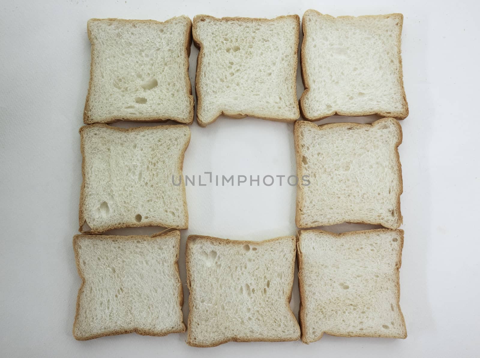 Heap of Stacked Sliced Bread on White Background. by TEERASAK