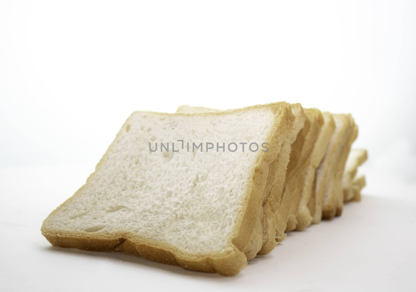 Loaf of sliced bread isolated on a white background. by TEERASAK