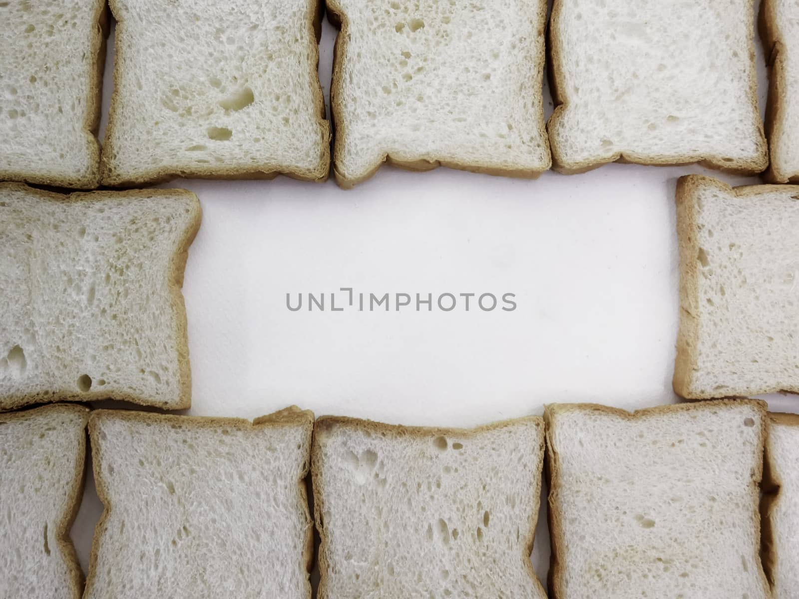 Heap of Stacked Sliced Bread on White Background. by TEERASAK
