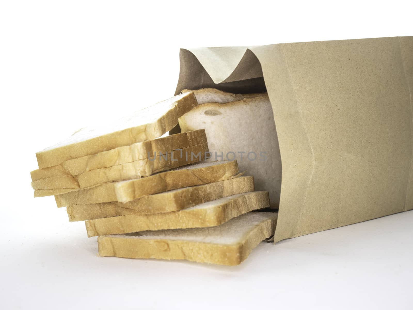 Bread full sliced in paper bag isolated on white background.