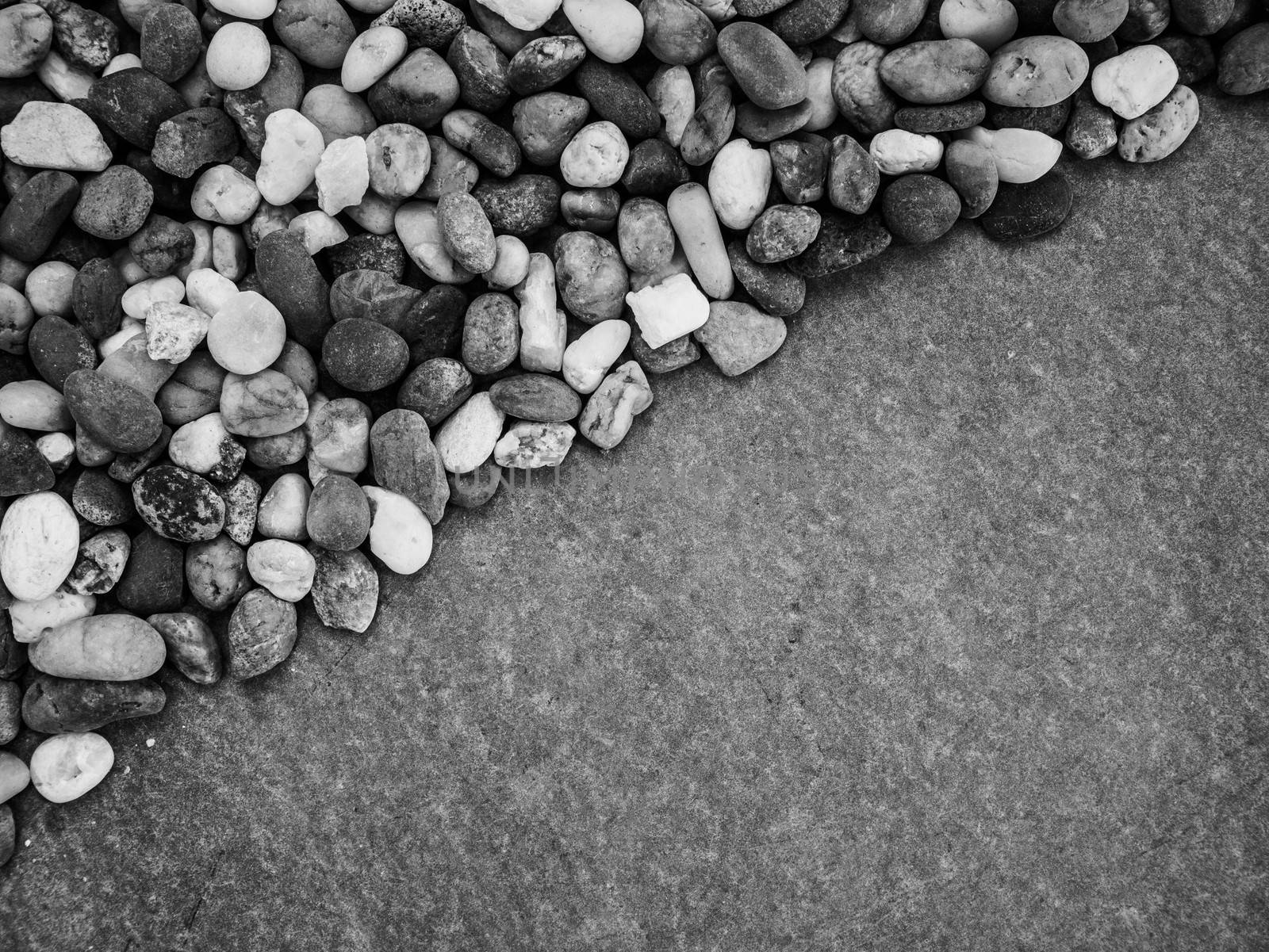 Pebbles pattern or small stones background in garden with copy space for your text. Black and white picture. by TEERASAK