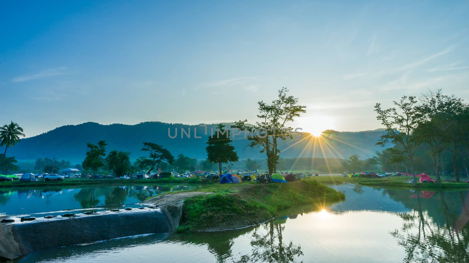 Camping and tent in nature park with sunrise