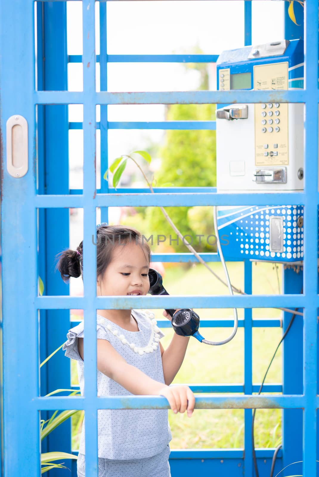asian little girl in the phone booth