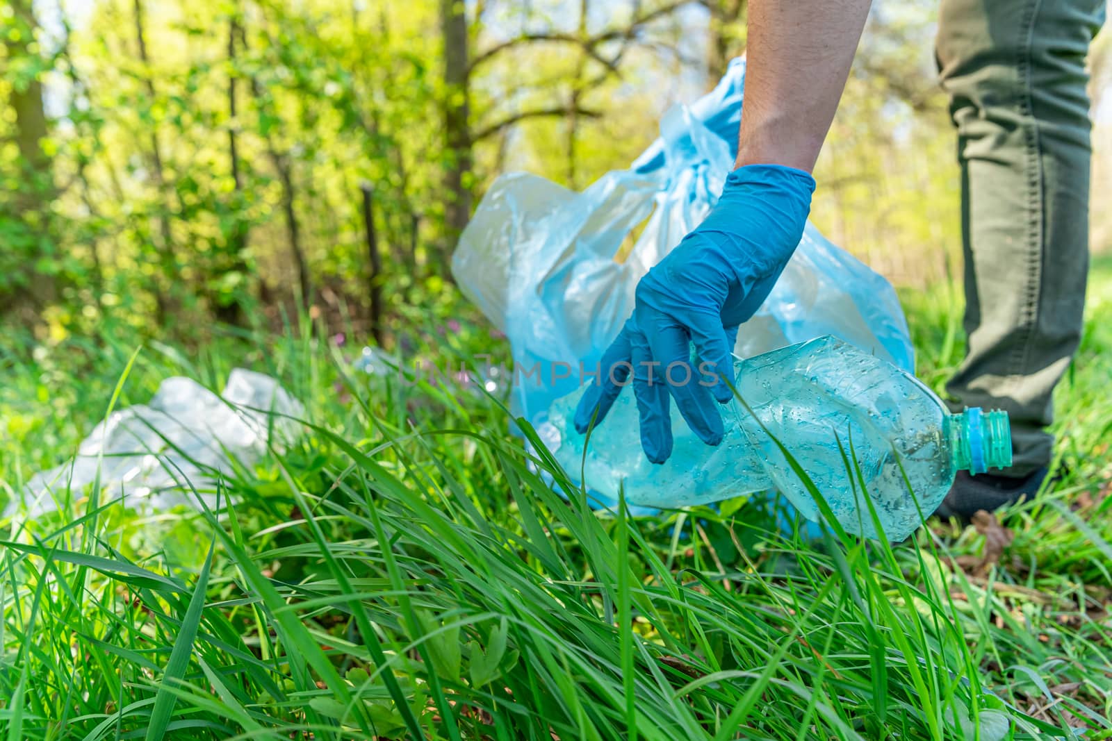 global pollution of the planet with plastic waste. Volunteers help ecology by clearing forests and meadows by collecting waste.