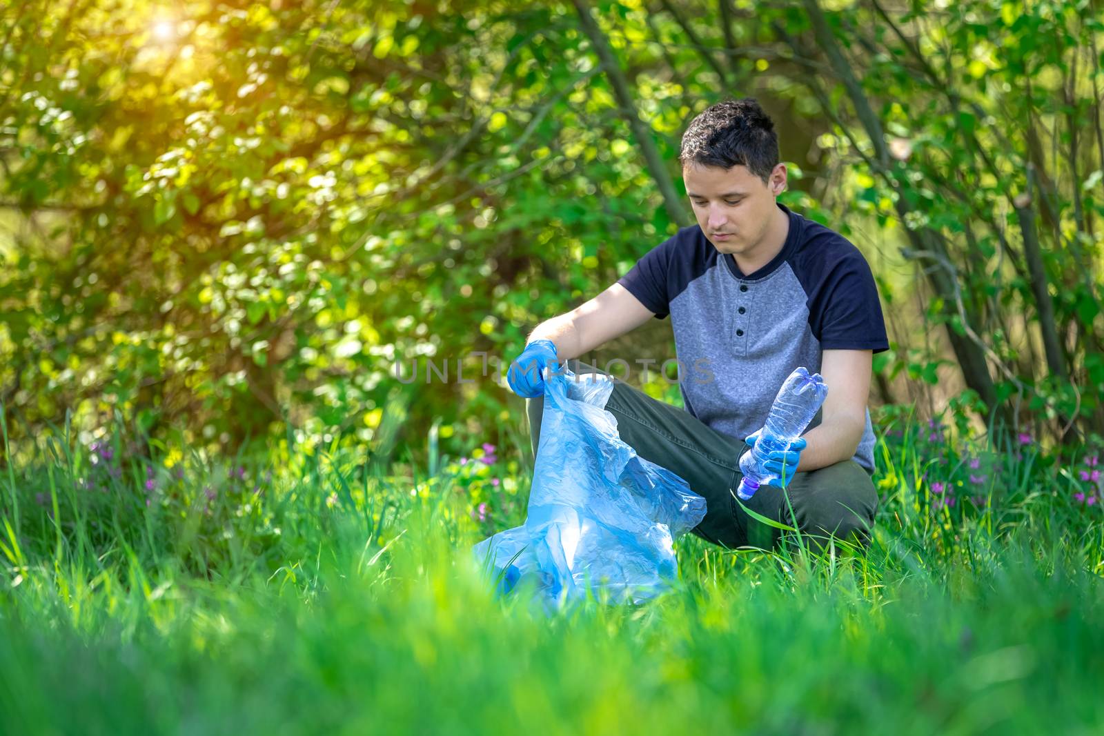 cleaning nature by collecting plastic waste, plastic bottles from the drink cause an ecological disaster.