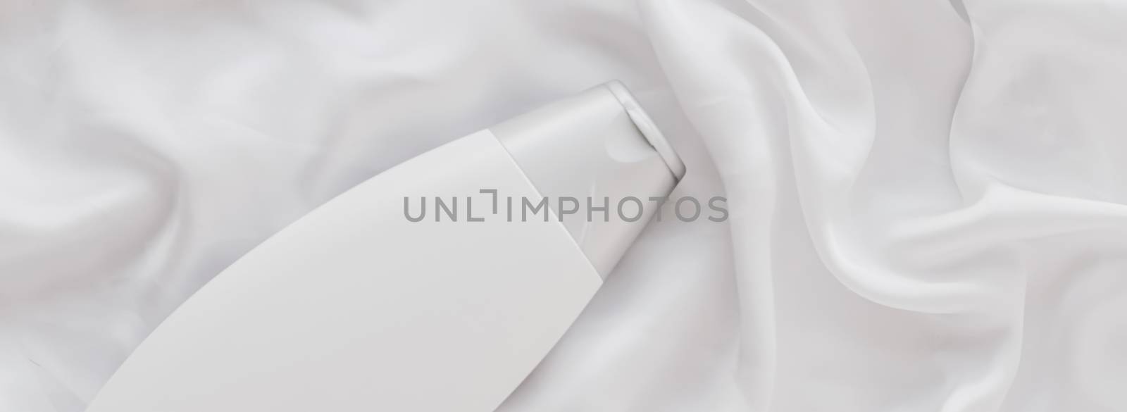 Blank label cosmetic container bottle as product mockup on white silk background, hygiene and healthcare