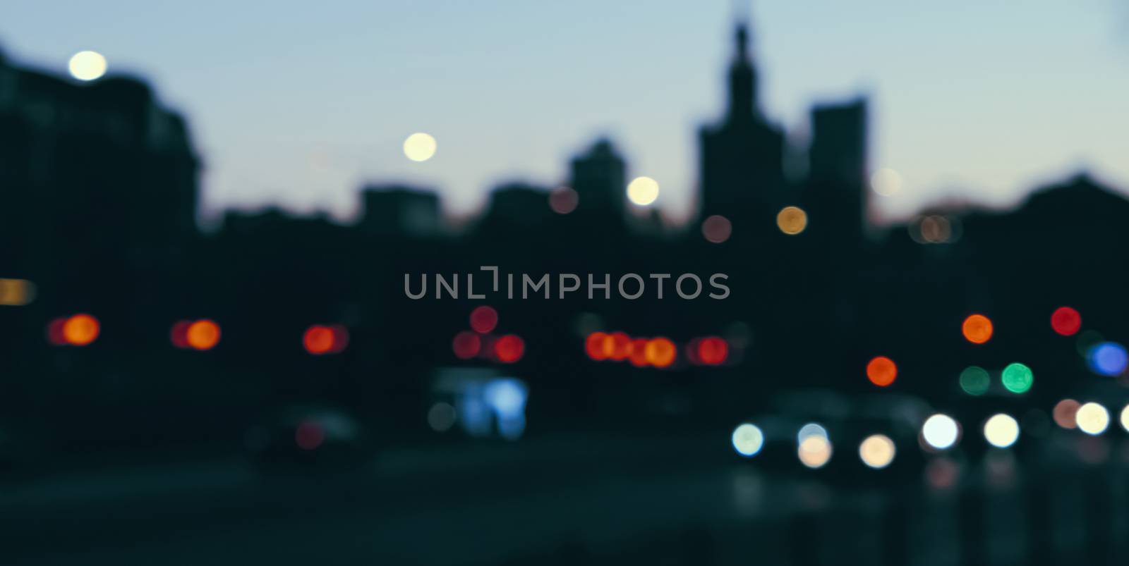 Blurry cityscape silhouette of a European city as background, evening view of Warsaw, Poland