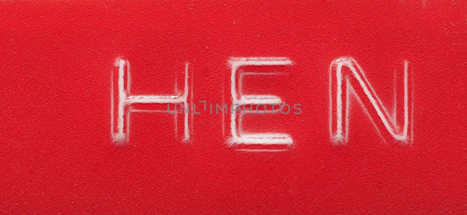 HEN label written with red plastic embossing tape