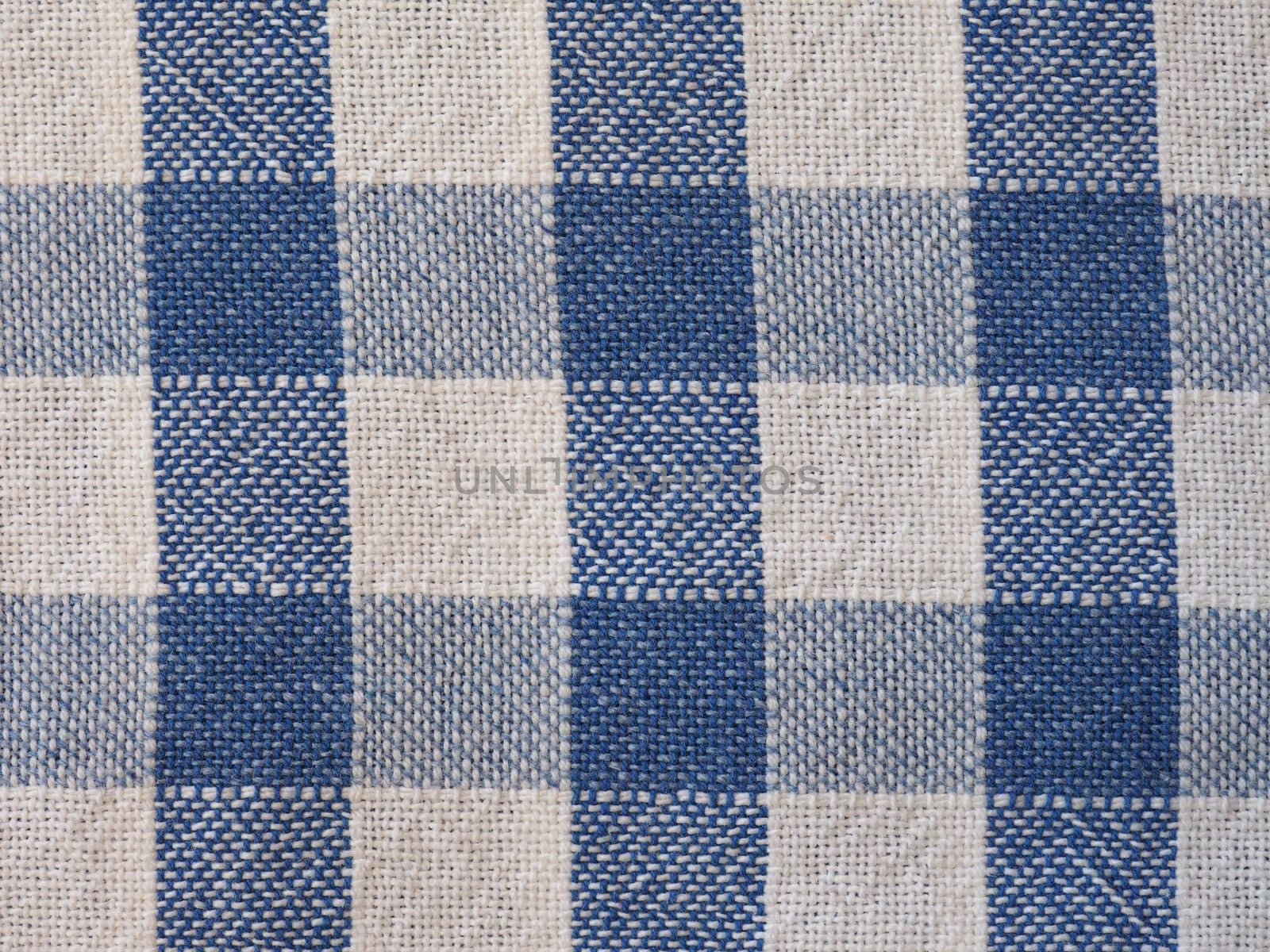 blue and white checkered fabric background by claudiodivizia