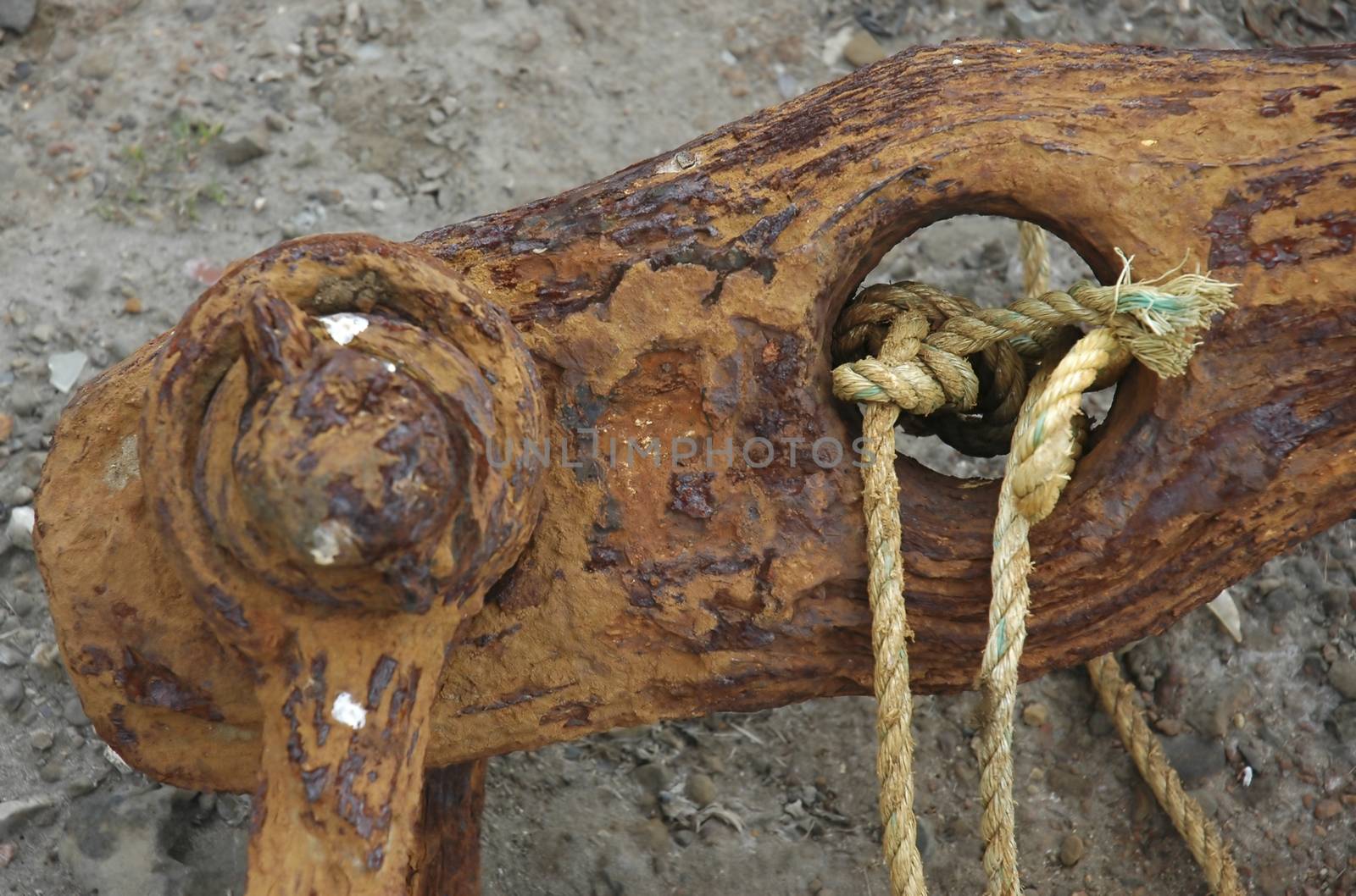 A rusty anchor on a beach