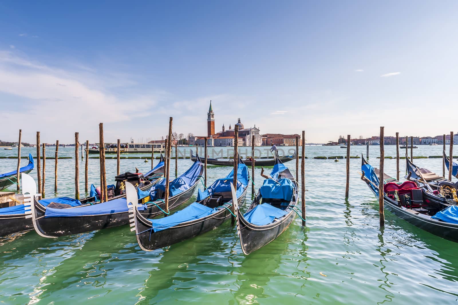 Gondolas and San Giorgio Maggiore Island in the background in the Venice Lagoon in Veneto, Italy by Frederic