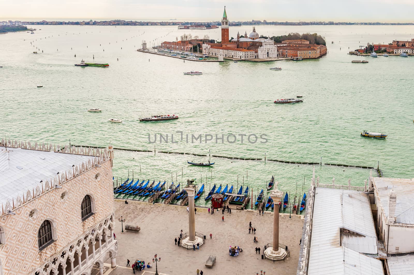 Aerial view of Saint Mark's Square and the gondolas, as well as the lagoon and the island of San Giorgio Maggiore, from the top of the bell tower of Saint Mark's Square in Venice.