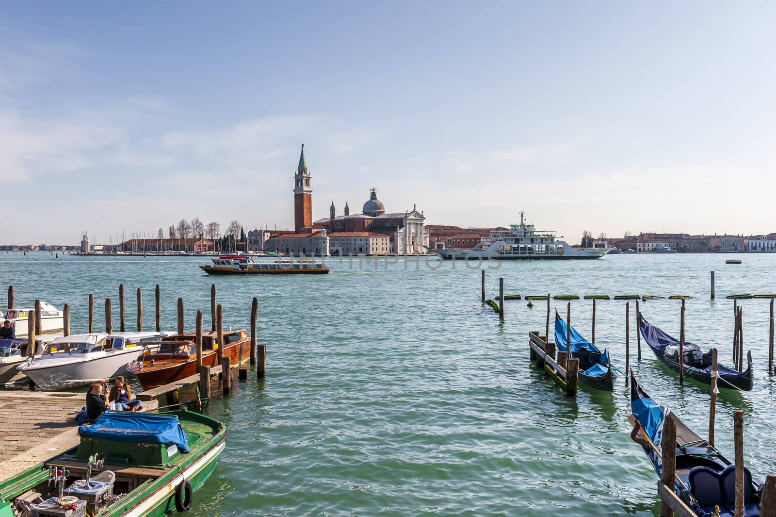 Gondolas and Island of San Giorgio Maggiore in the background in the lagoon of Venice in Veneto, Italy by Frederic