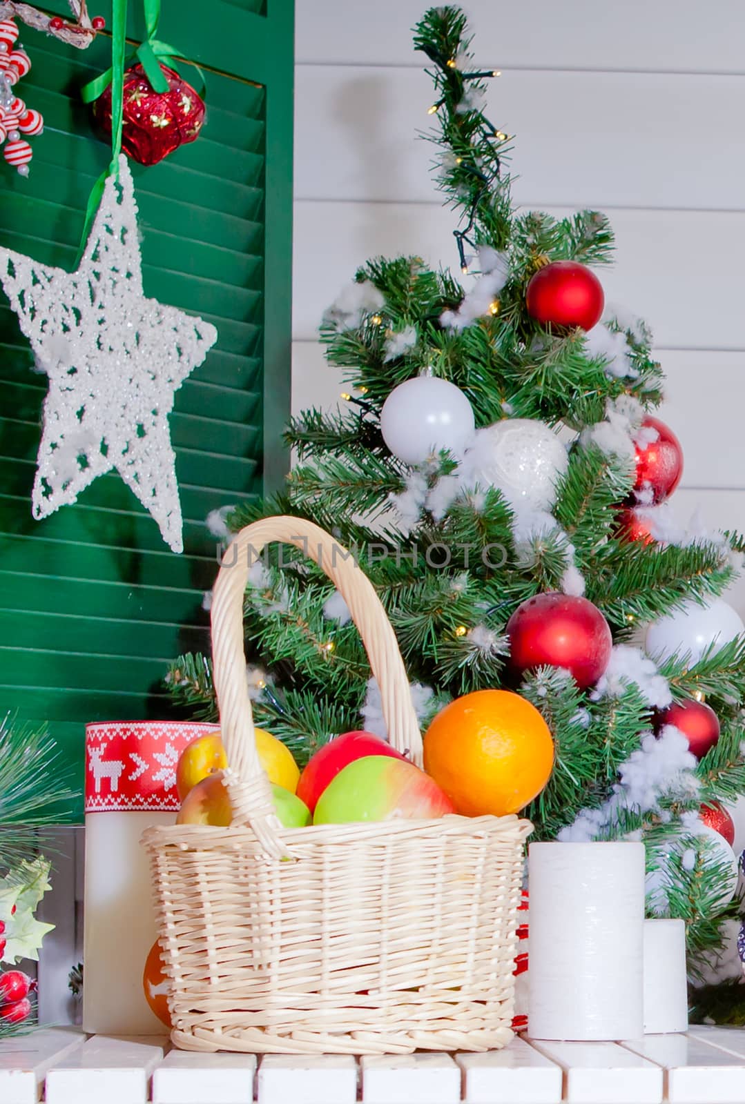 A basket of fruit on the background of the Christmas tree and the Christmas star