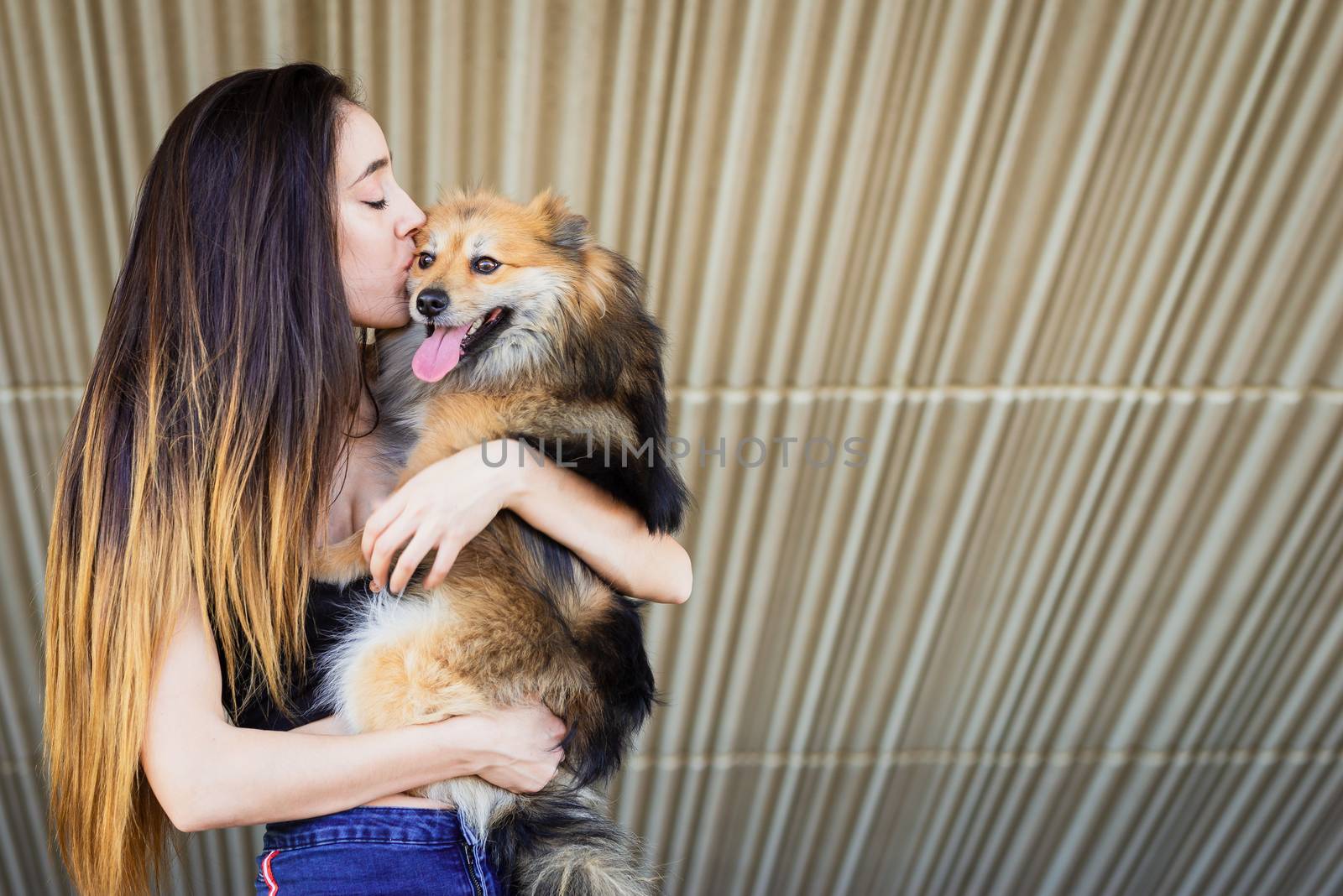 woman kissing dog with copy space for text by Fotoeventis