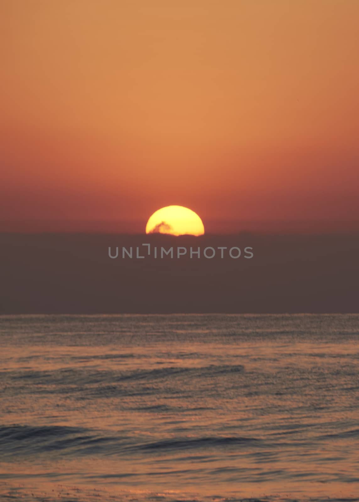 Sunrise in the ocean, the sun appears by raul_ruiz