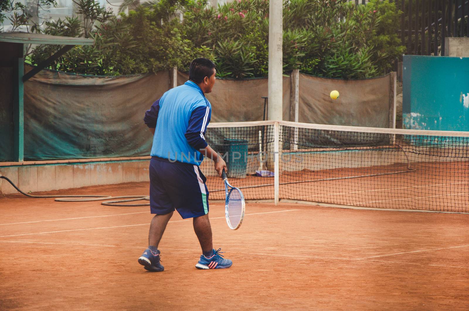 Tennis player with a racket in full match