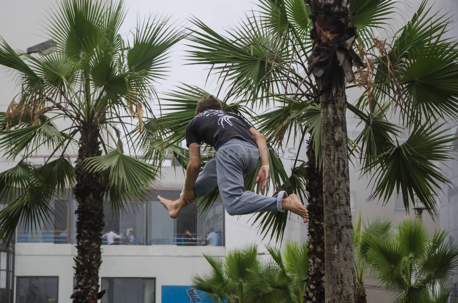 Man on rope jumping and doing balance