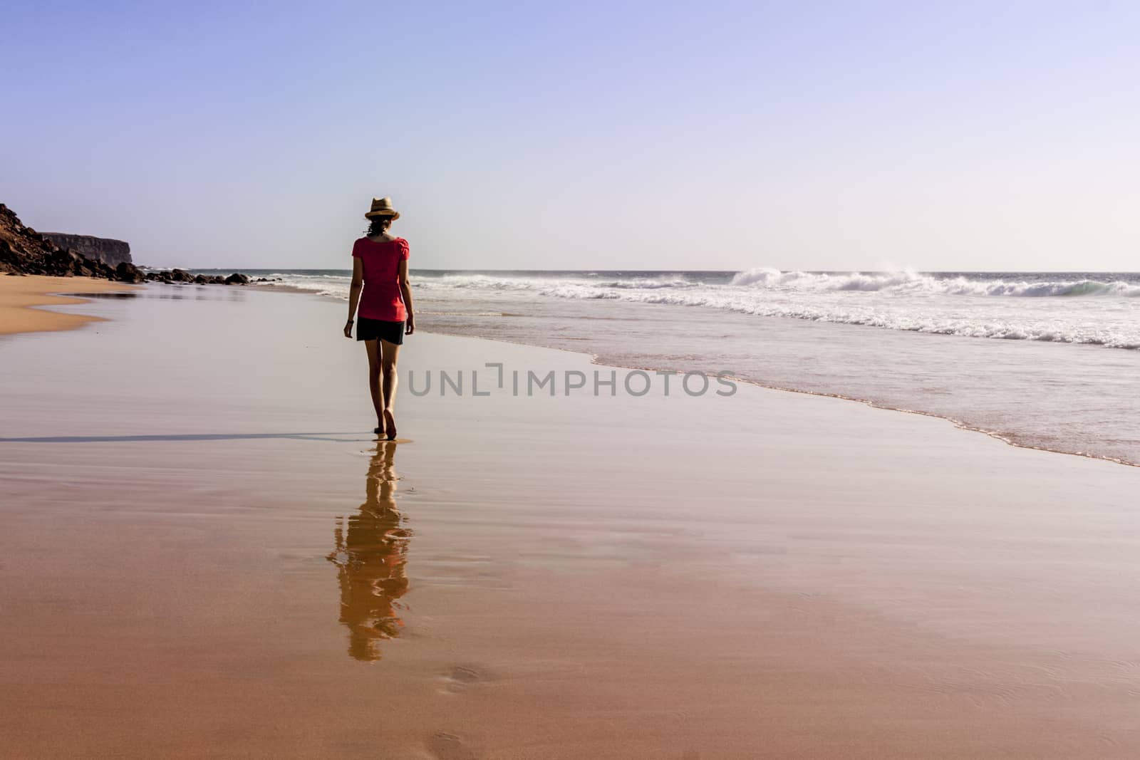 Solitary girl on beach looking at the sea by tanaonte