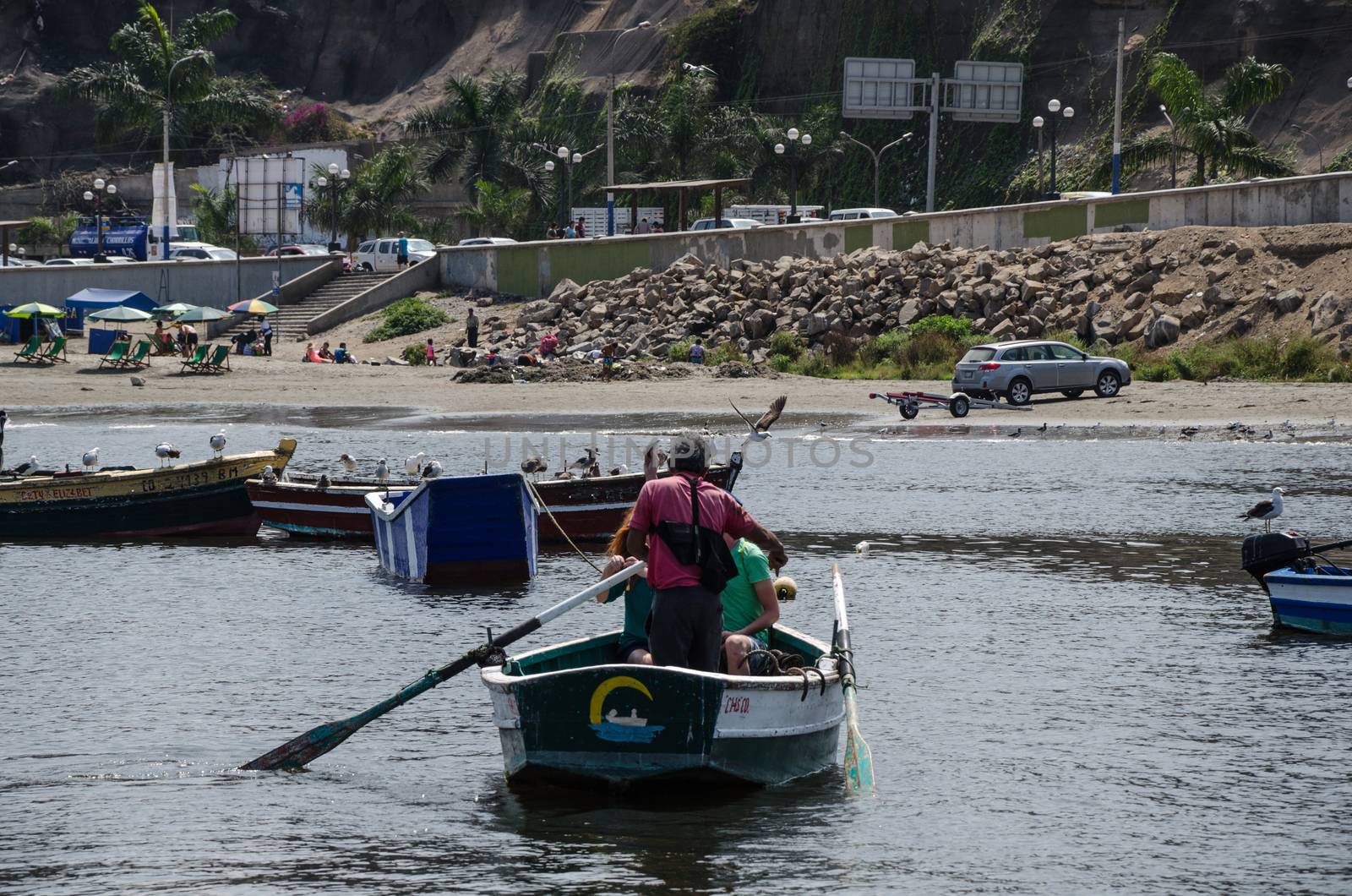 Old man driving a boat at sea