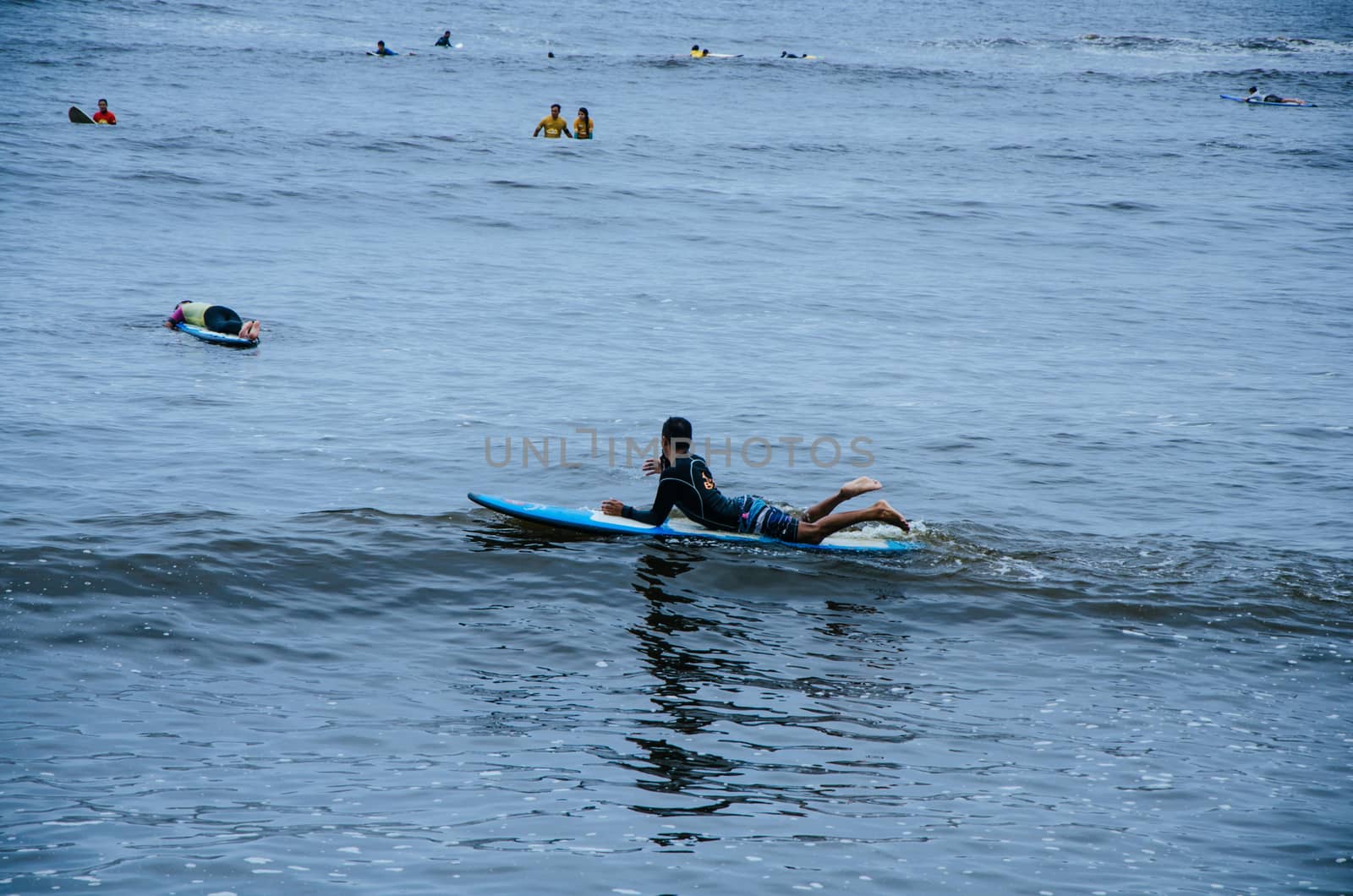 Surfer resting on his board in the sea
