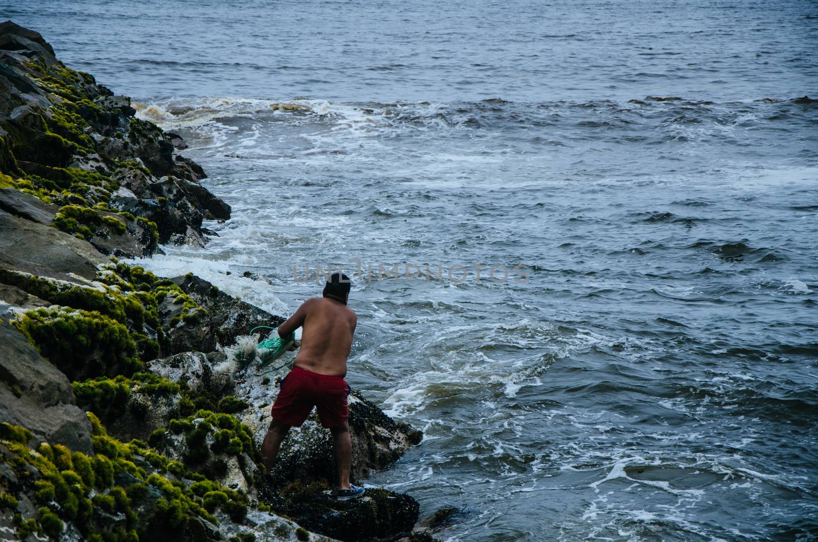 Fisherman throwing his net to catch some fish