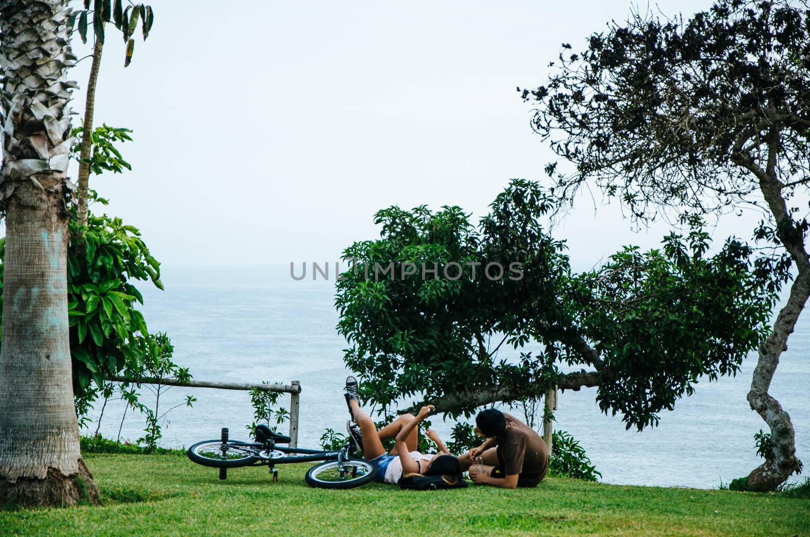 A couple lying on the lawn by Peruphotoart
