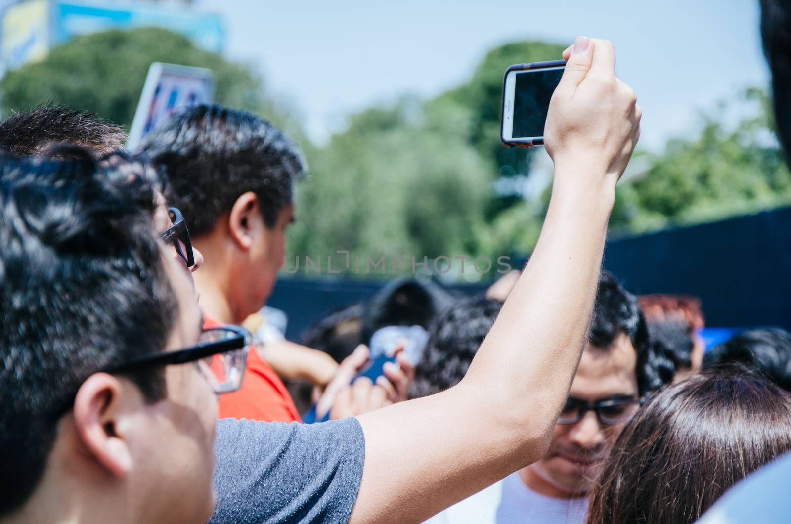 Man with cell phone in hand taking picture