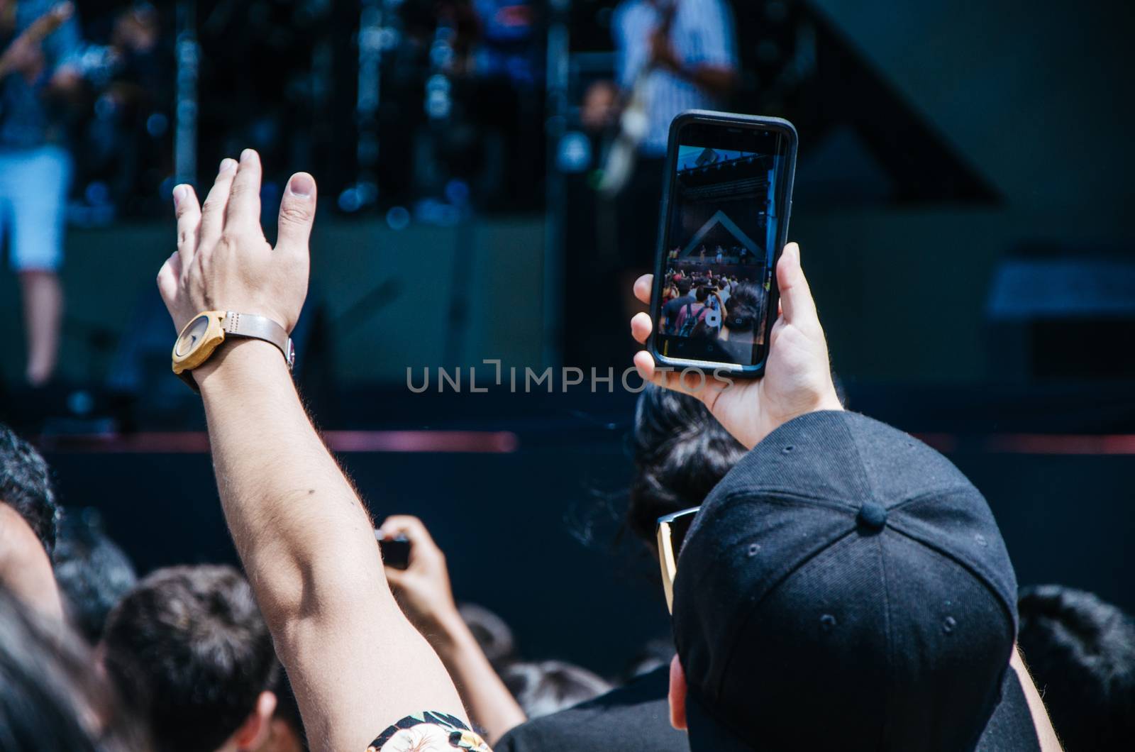 Man with cell phone in hand taking picture