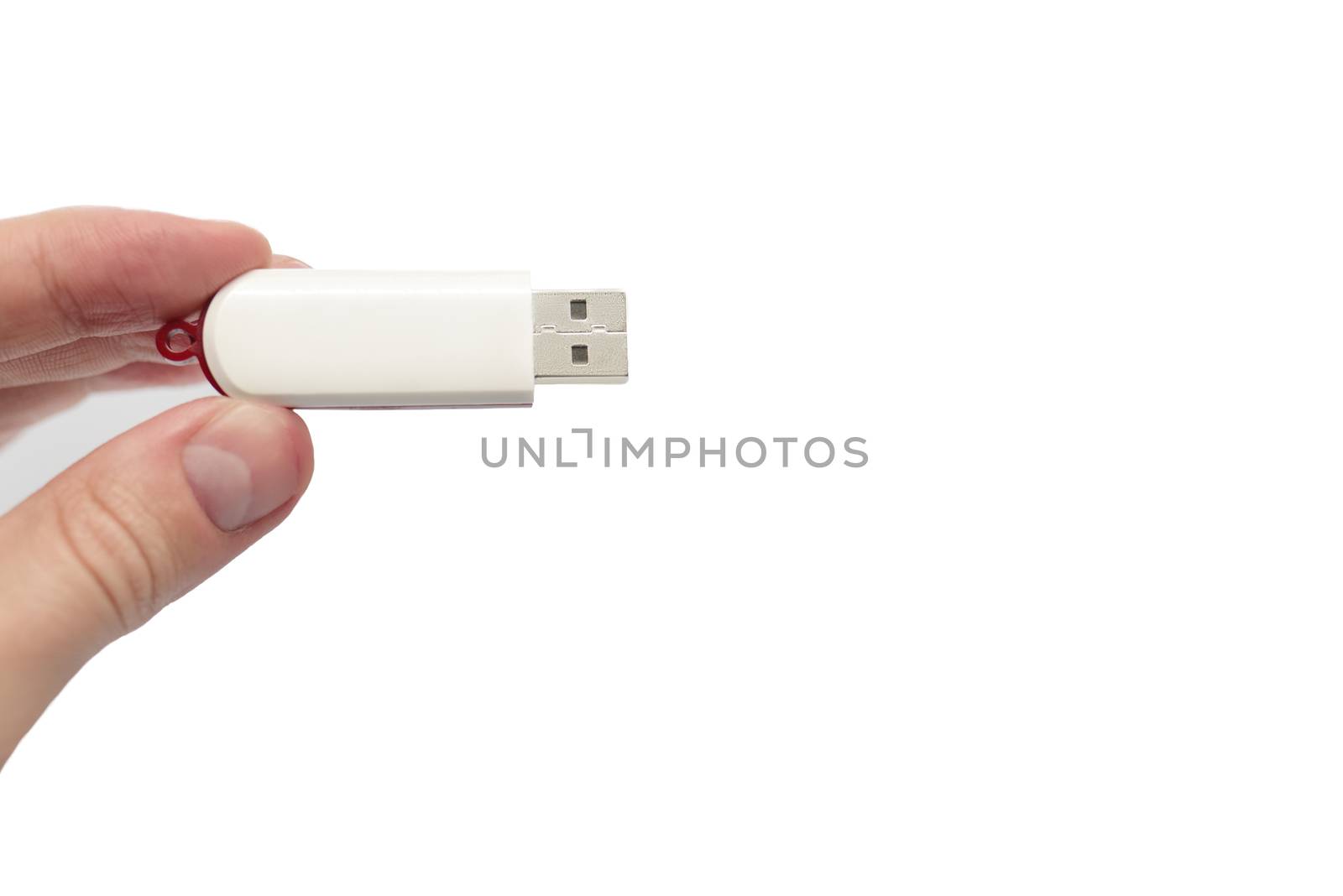 USB flash drive close up shot held between fingers by Caucasian male hand isolated against white background 2020