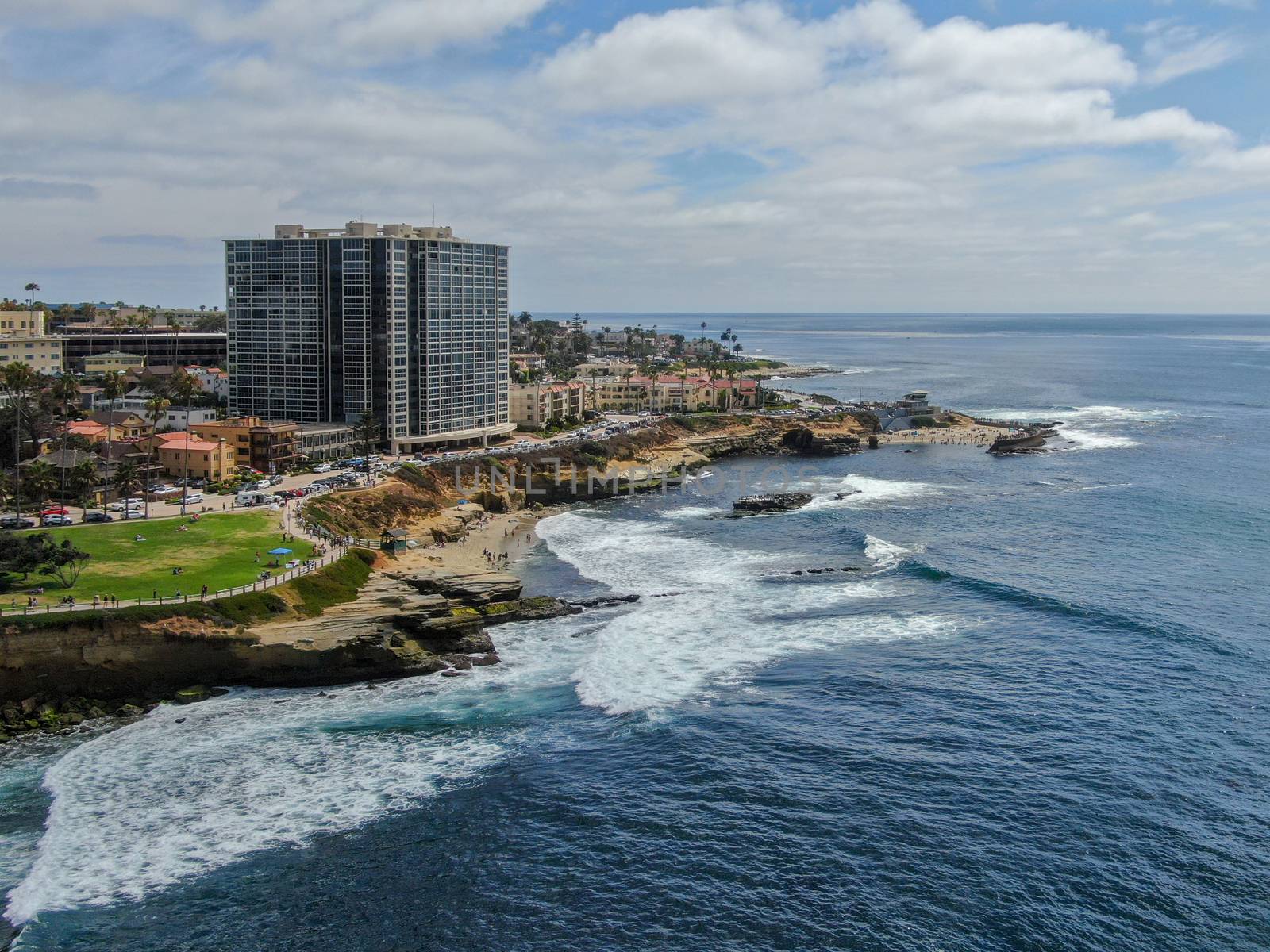 Aerial view of La Jolla coast, San Diego, California. Beach and blue sea with small waves. Hilly seaside of curving coastline along the Pacific.