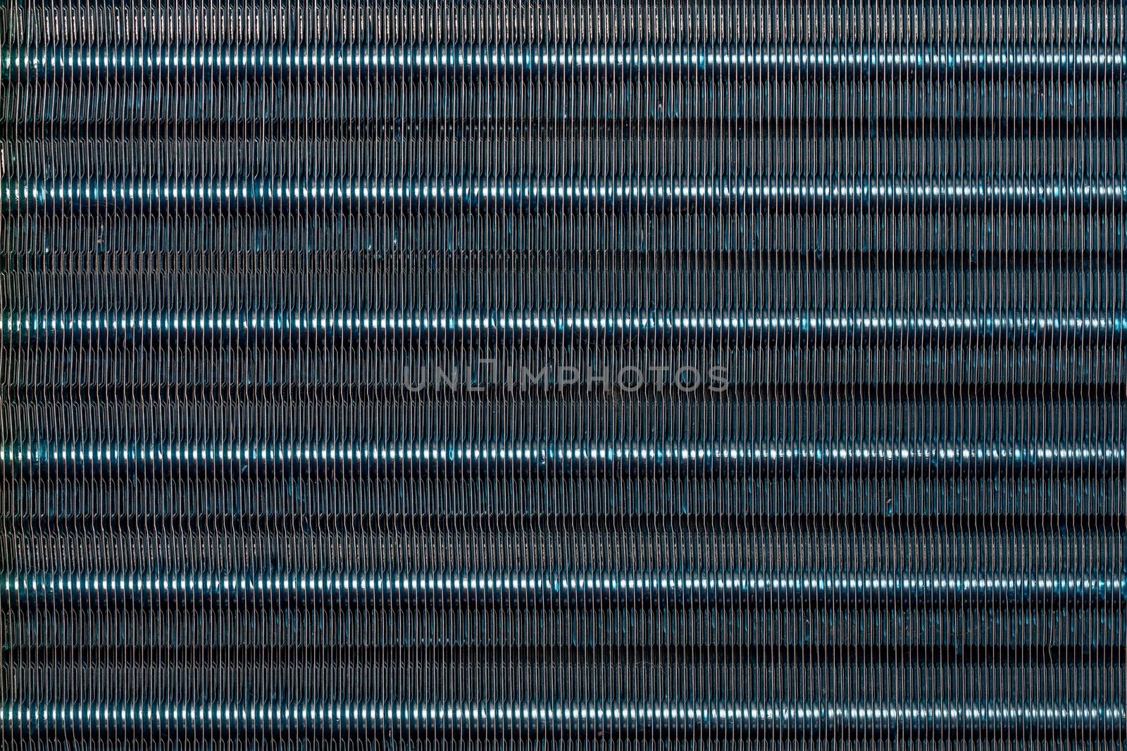 blue hydrophilic coaterd heat radiator - air conditioner evaporator close-up coil texture.