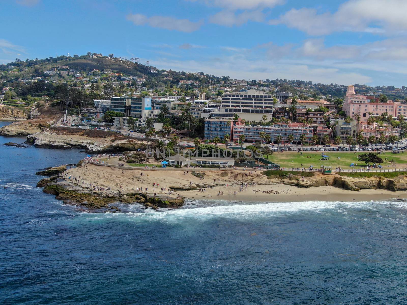 Aerial view of La Jolla coast, San Diego, California. Beach and blue sea with small waves. Hilly seaside of curving coastline along the Pacific.