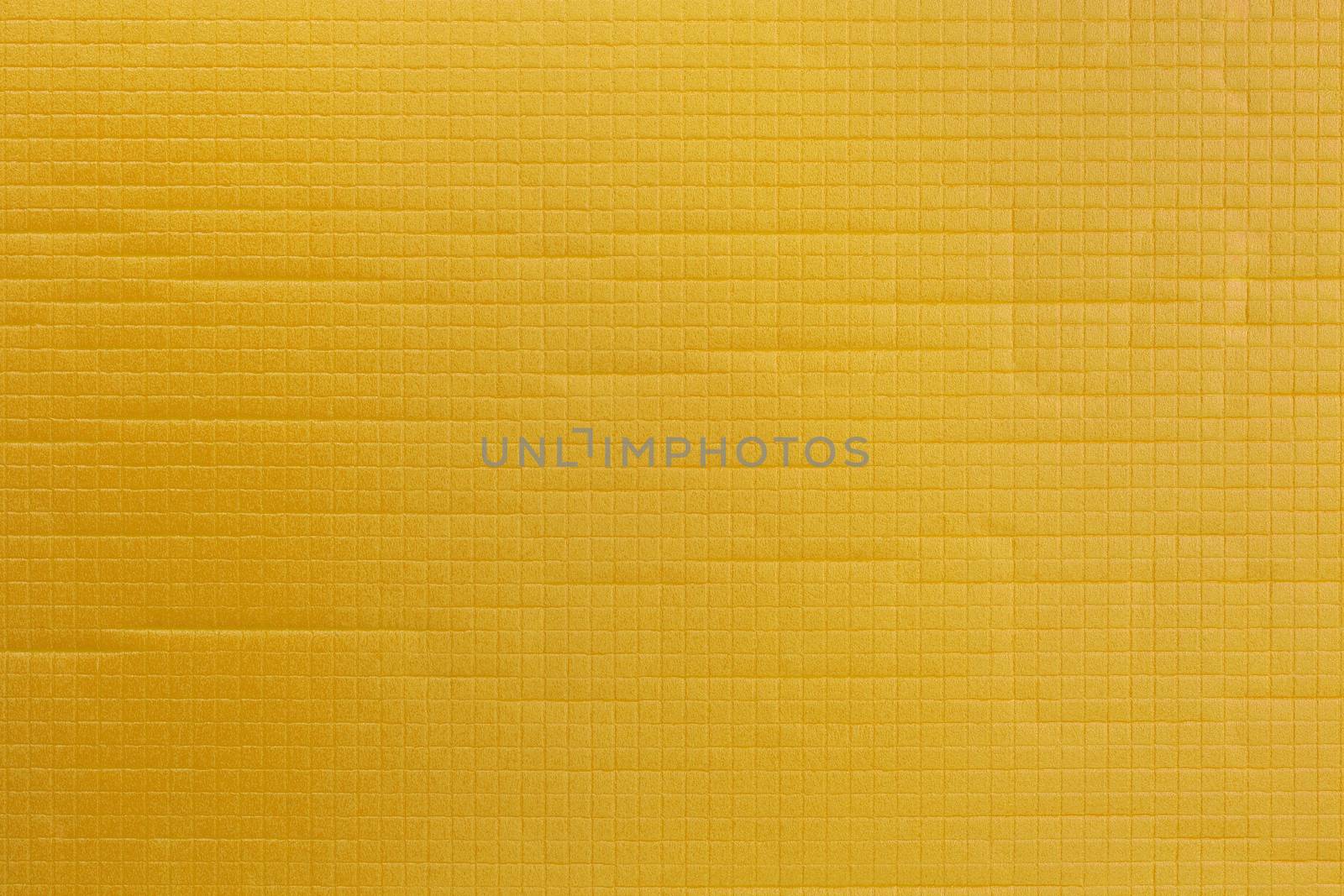 yellow soft sport or yoga foam mat surface flat texture and background.