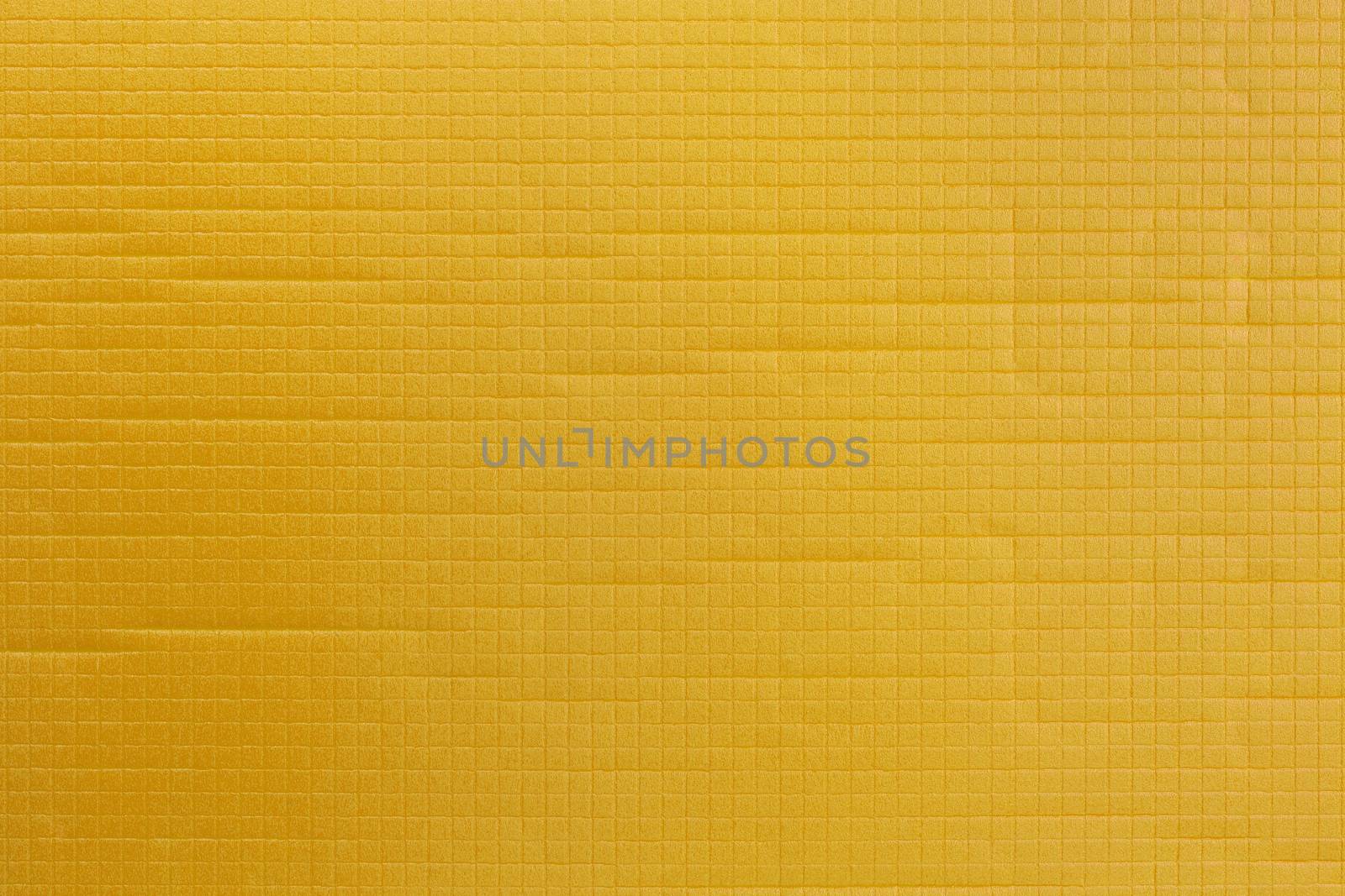 yellow soft sport or yoga foam mat surface flat texture and background.