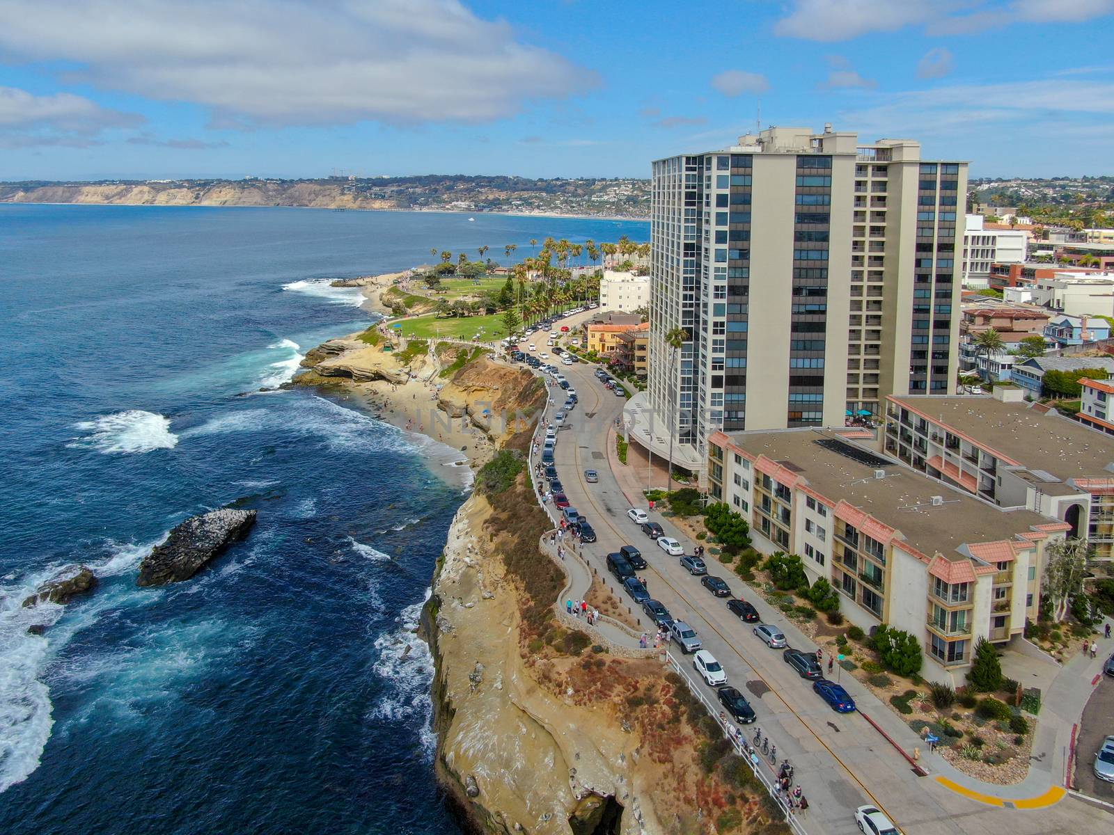 Aerial view of La Jolla coast, San Diego, California. Beach and blue sea with small waves. Hilly seaside of curving coastline along the Pacific.