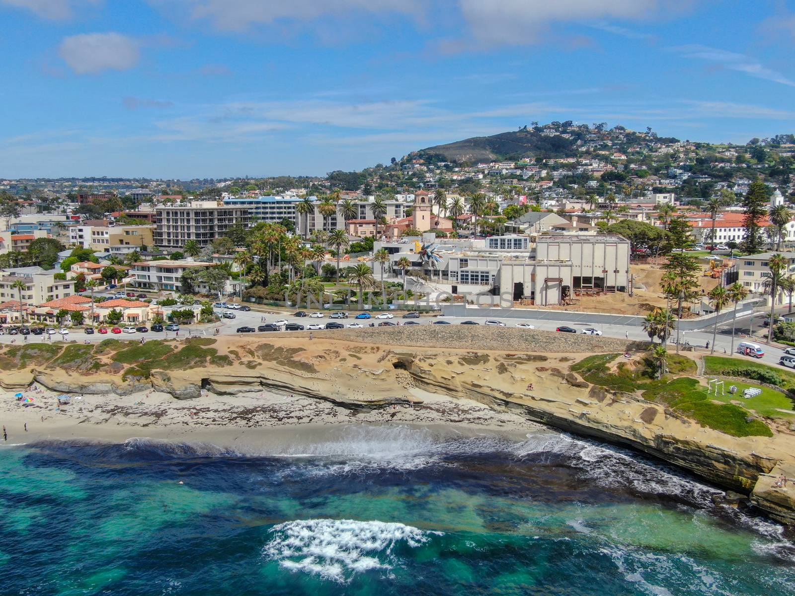 Aerial view of La Jolla coast, San Diego, California. Beach and blue sea with small waves. Hilly seaside of curving coastline along the Pacific.