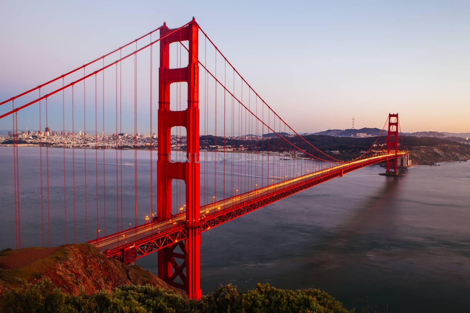 A view at dusk thru the Golden Gate Bridge towards downtown San Francisco. In California, USA.