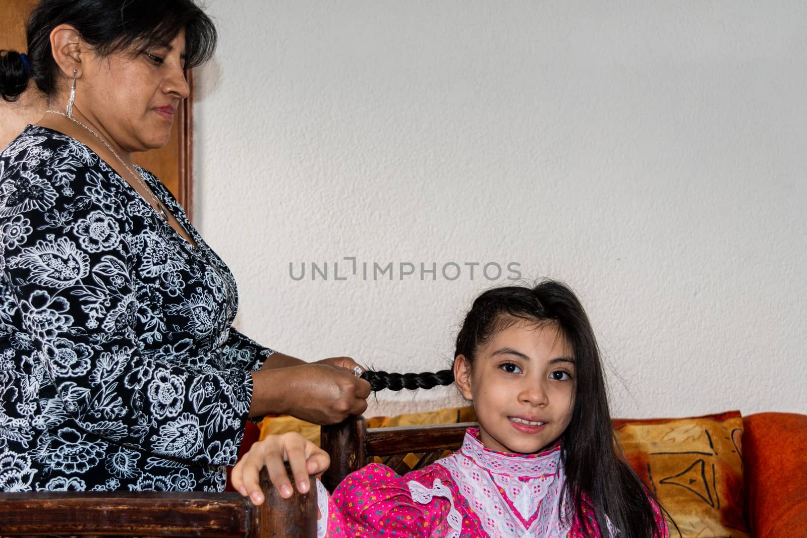woman putting makeup on girl of a typical mexican Catrina