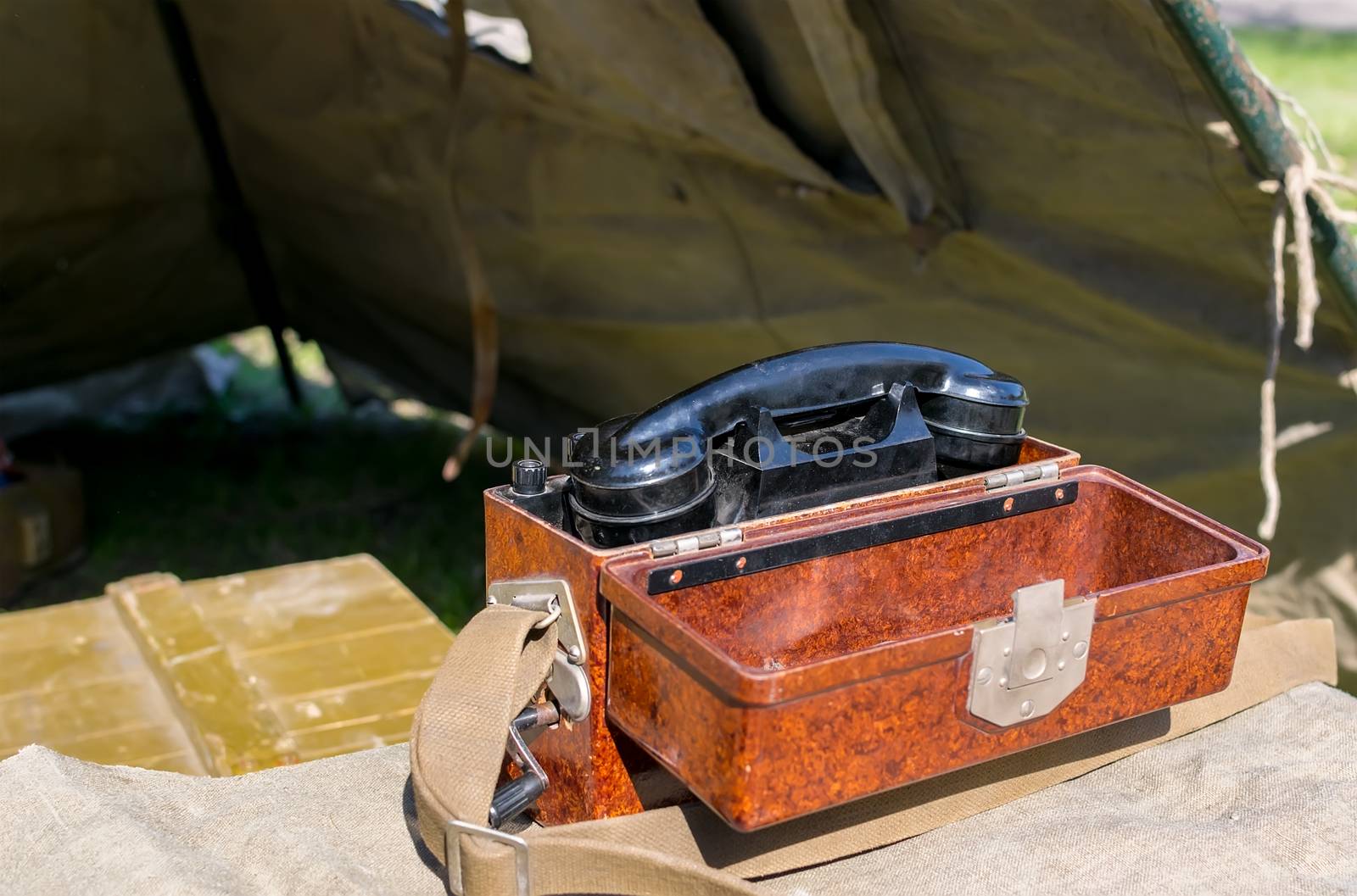 old military wired phone stands on the table in the army tent