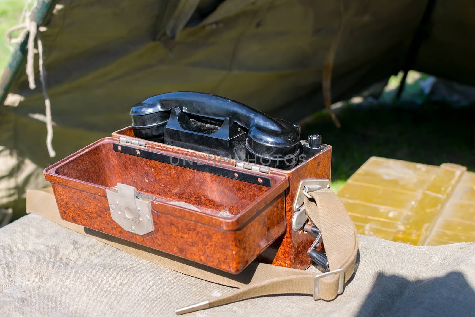 old military wired phone stands on the table in the army tent by jk3030