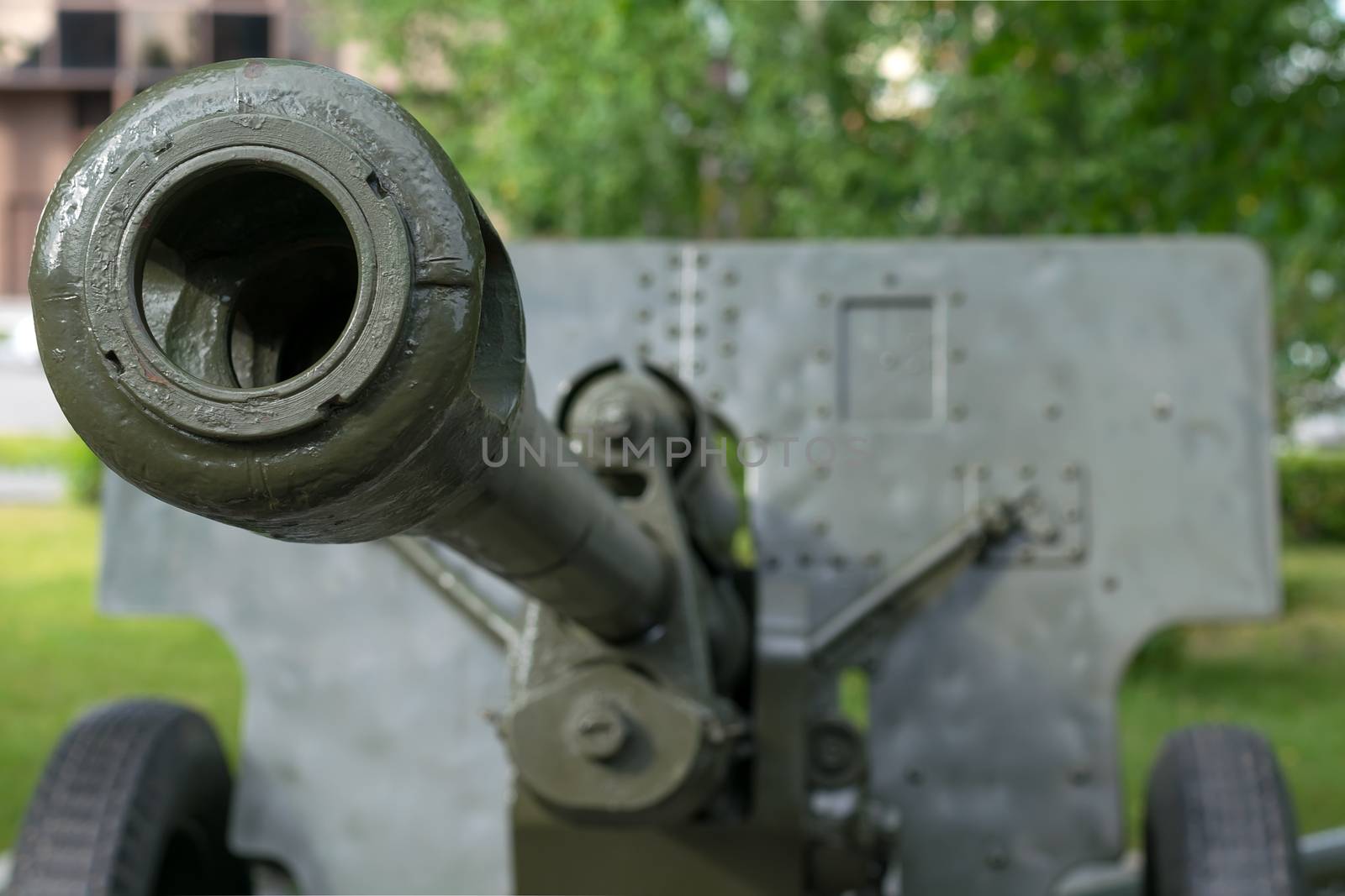a sample of a military cannon close-up on the background of a residential area by jk3030