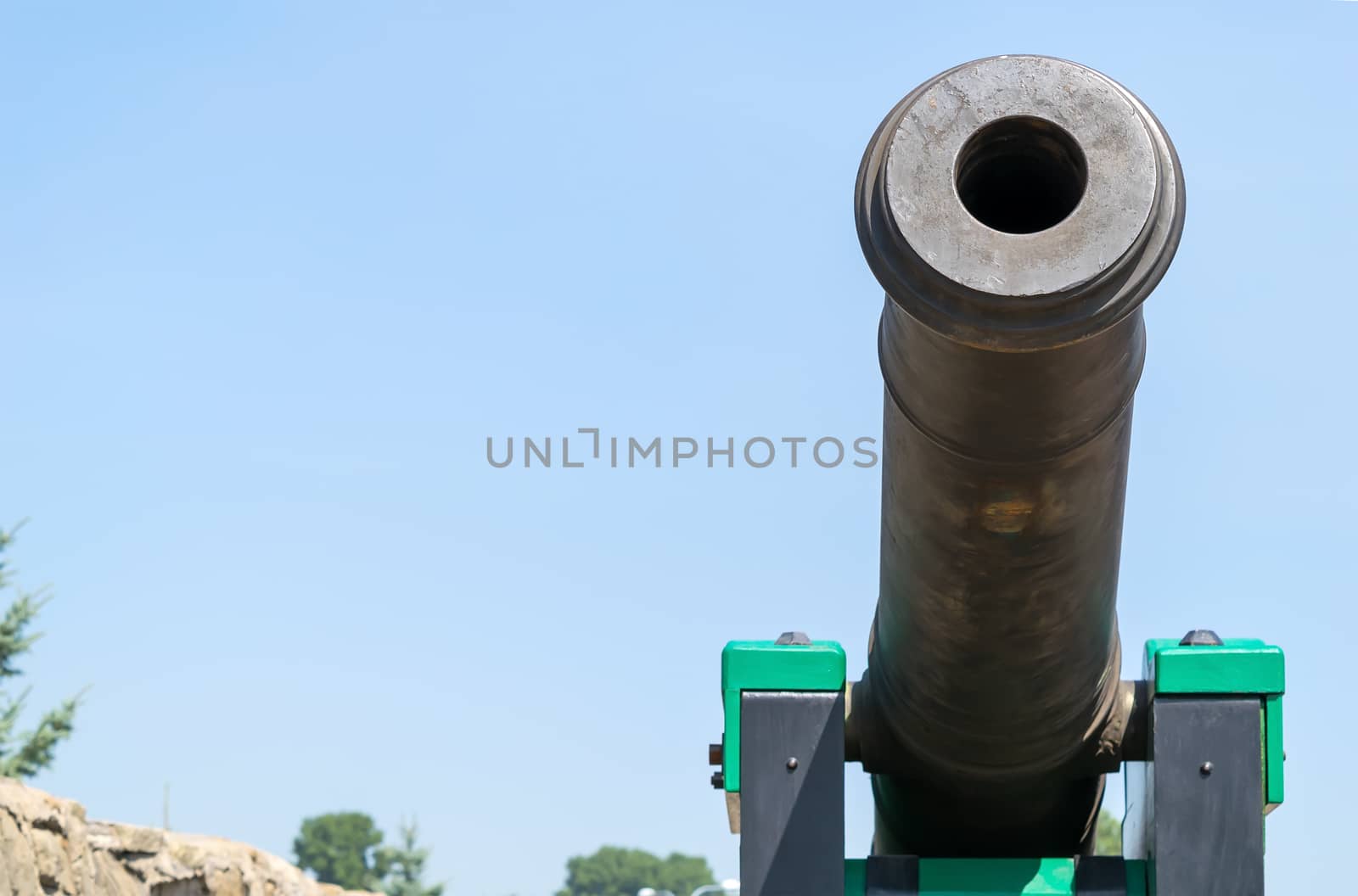 ancient gun on the territory of the fortress, close up, against the blue sky
