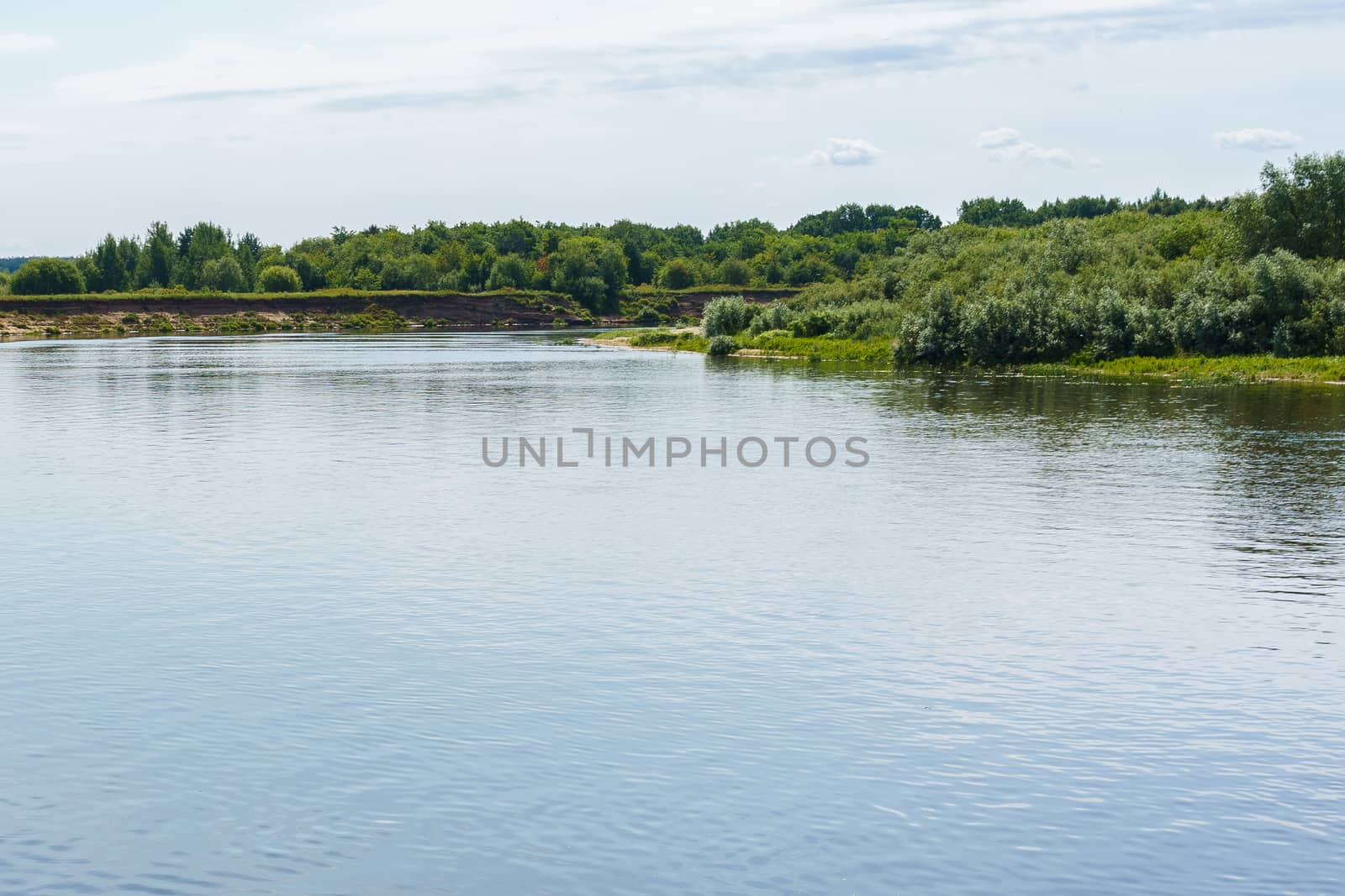 calm plain river among the banks covered with forest  by VADIM